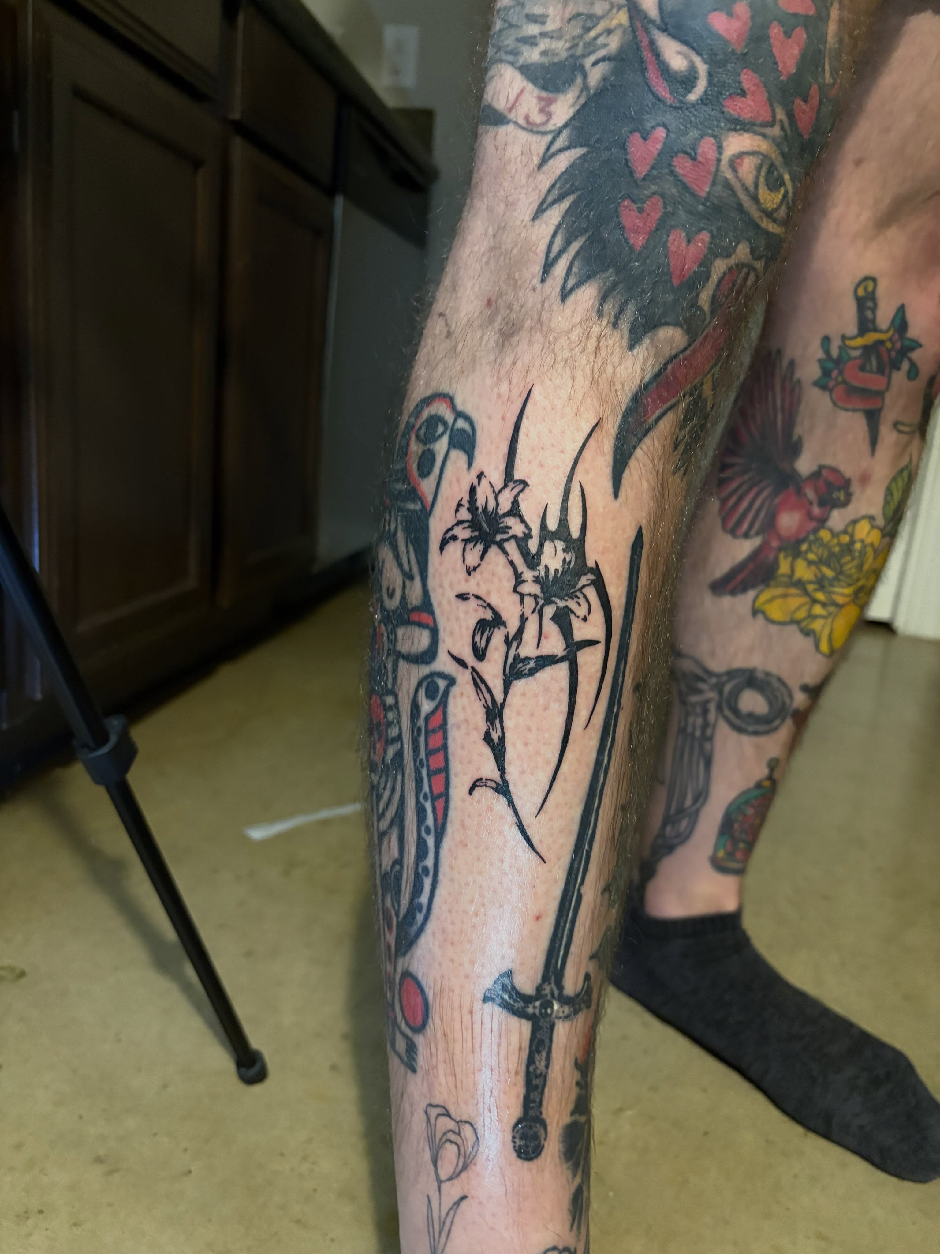 Flower and sword American traditional tattoo on the forearm by blastedbybk