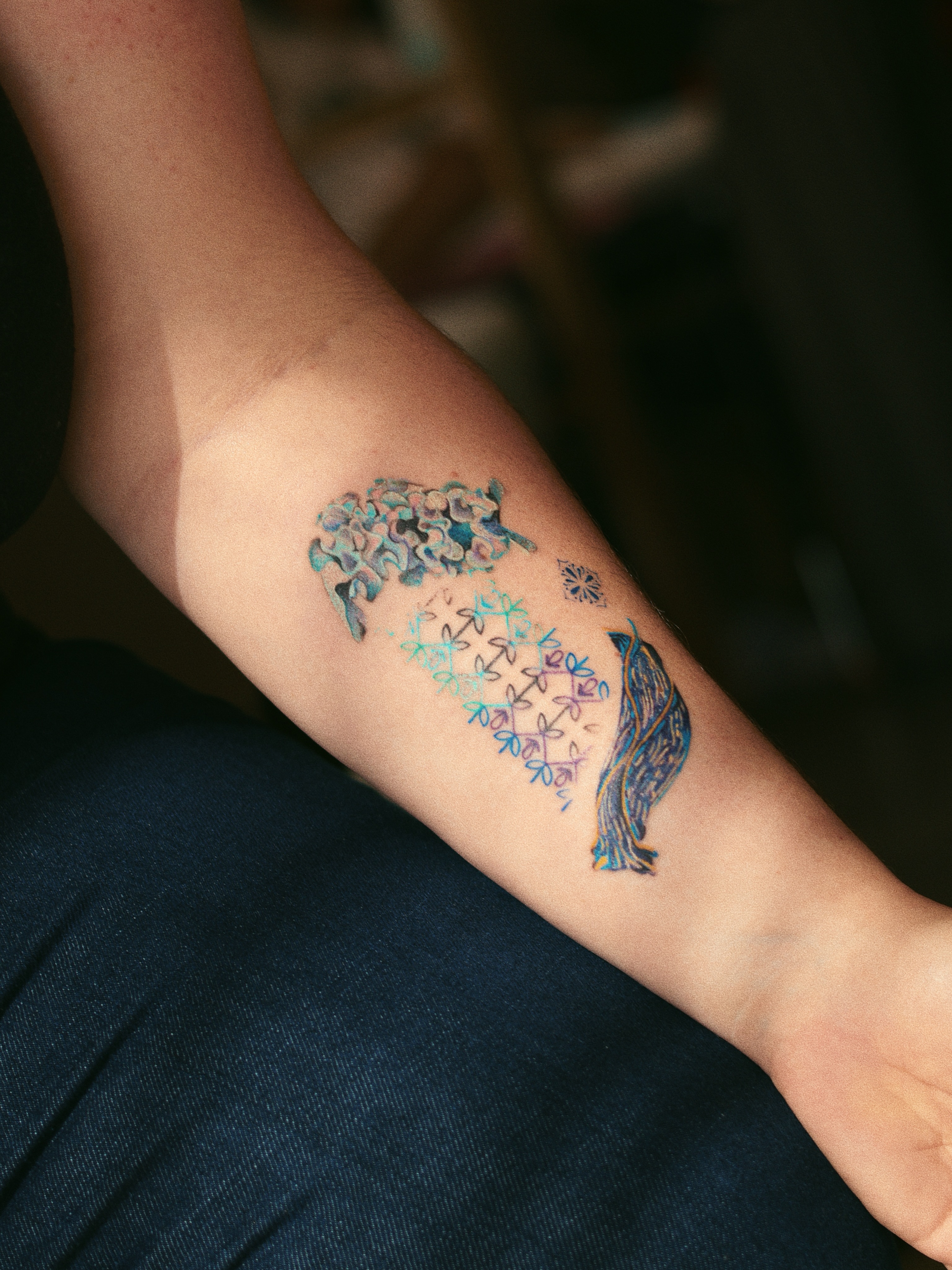 Flower and bird dotwork tattoo on the forearm by Micah Light (color micro realism, Los Angeles, California