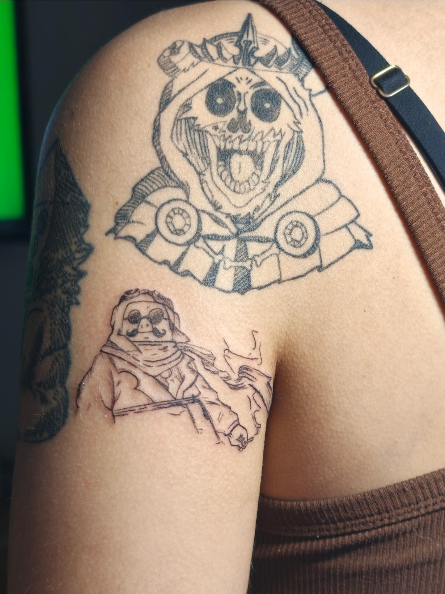 Skull with car black and grey tattoo on the shoulder by Dani Sandoval, Anaheim, California