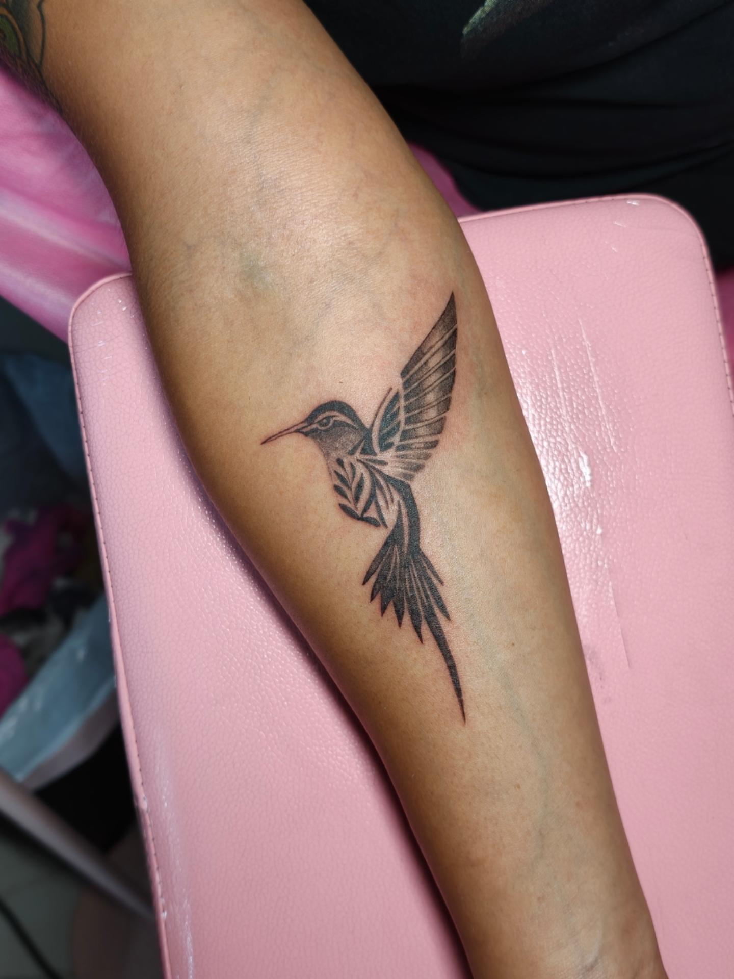 Hummingbird black and grey tattoo on the forearm by Dani Sandoval, Anaheim, California