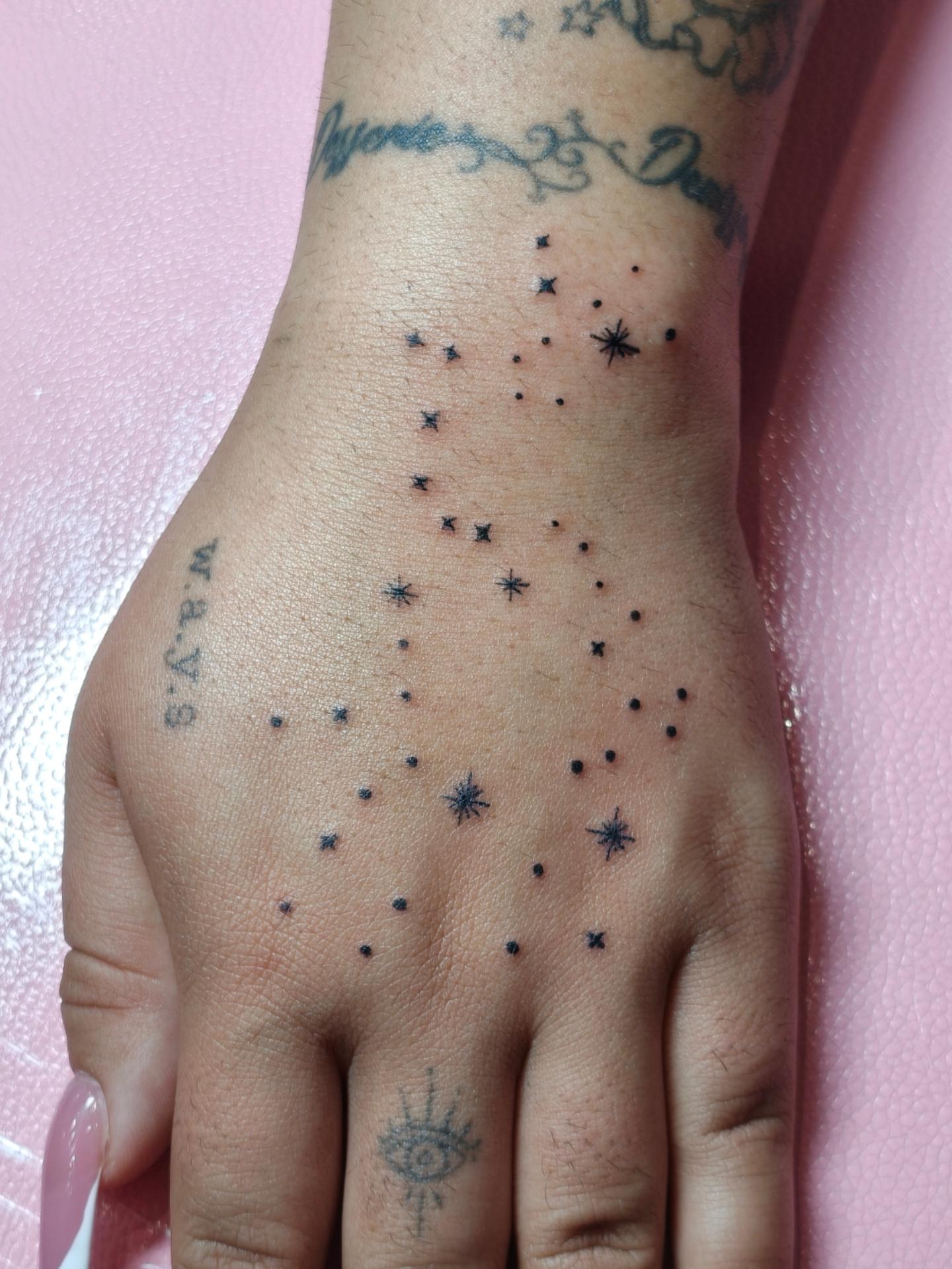 Constellation dotwork tattoo on the hand by Dani Sandoval, Anaheim, California
