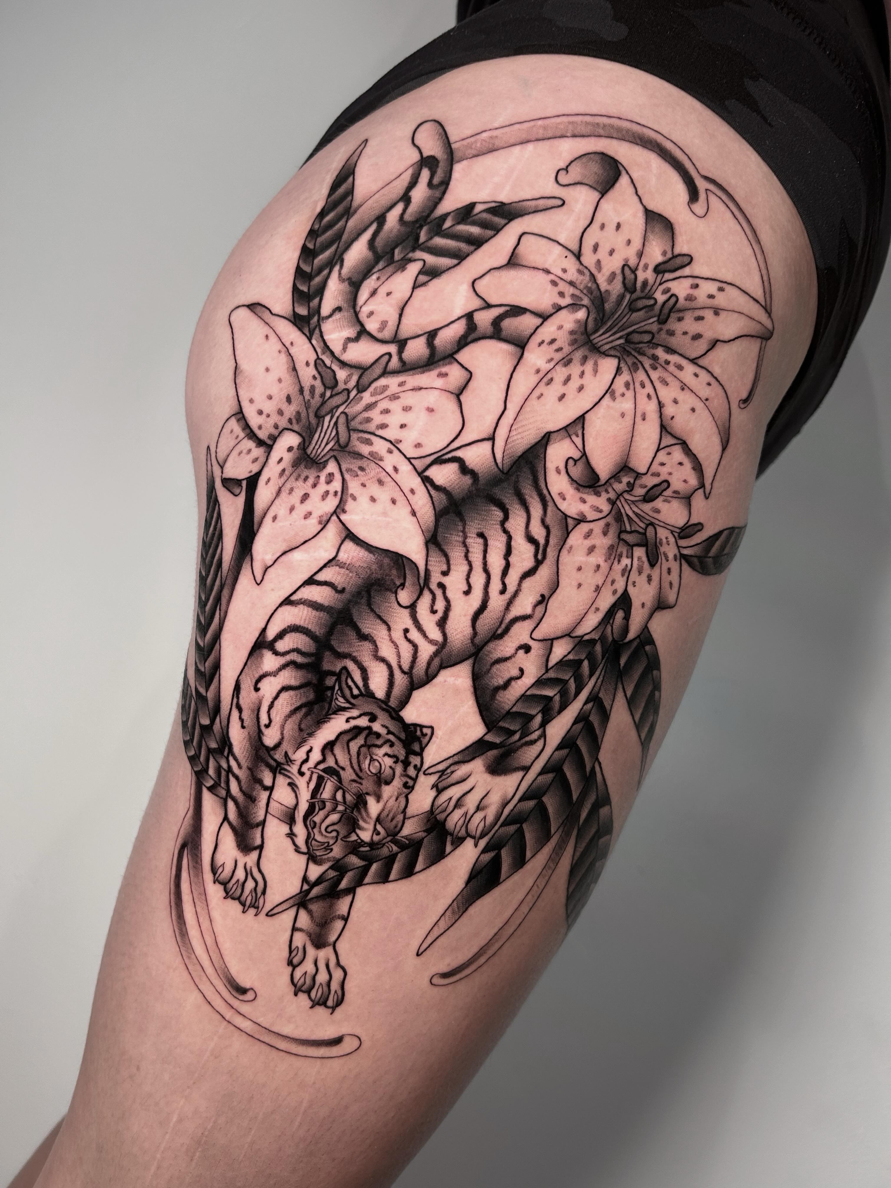 Tiger and lilies realism tattoo on the thigh by Salt Lake City tattoo artist