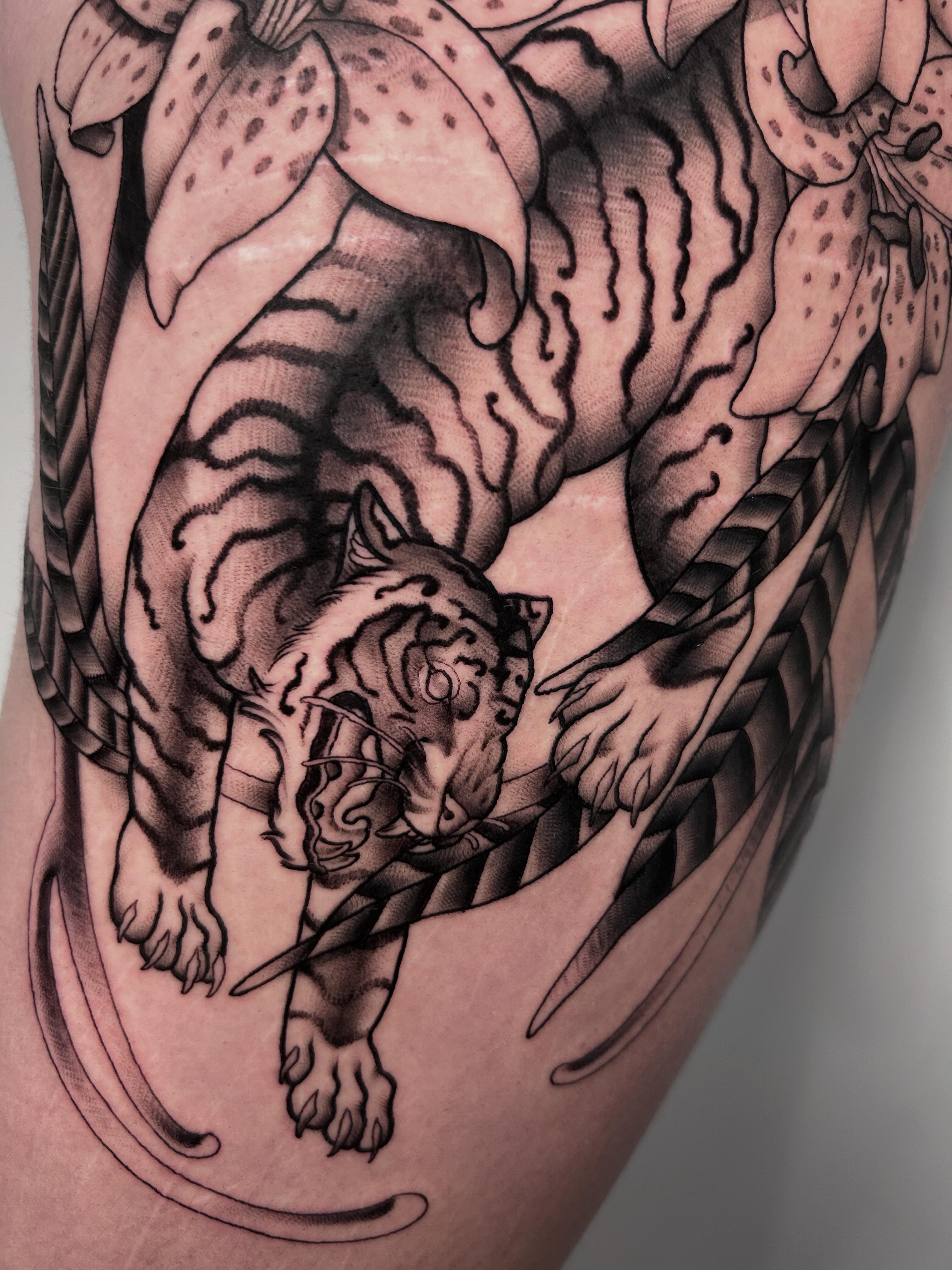 Tiger black and grey tattoo on the thigh by Salt Lake City tattoo artist