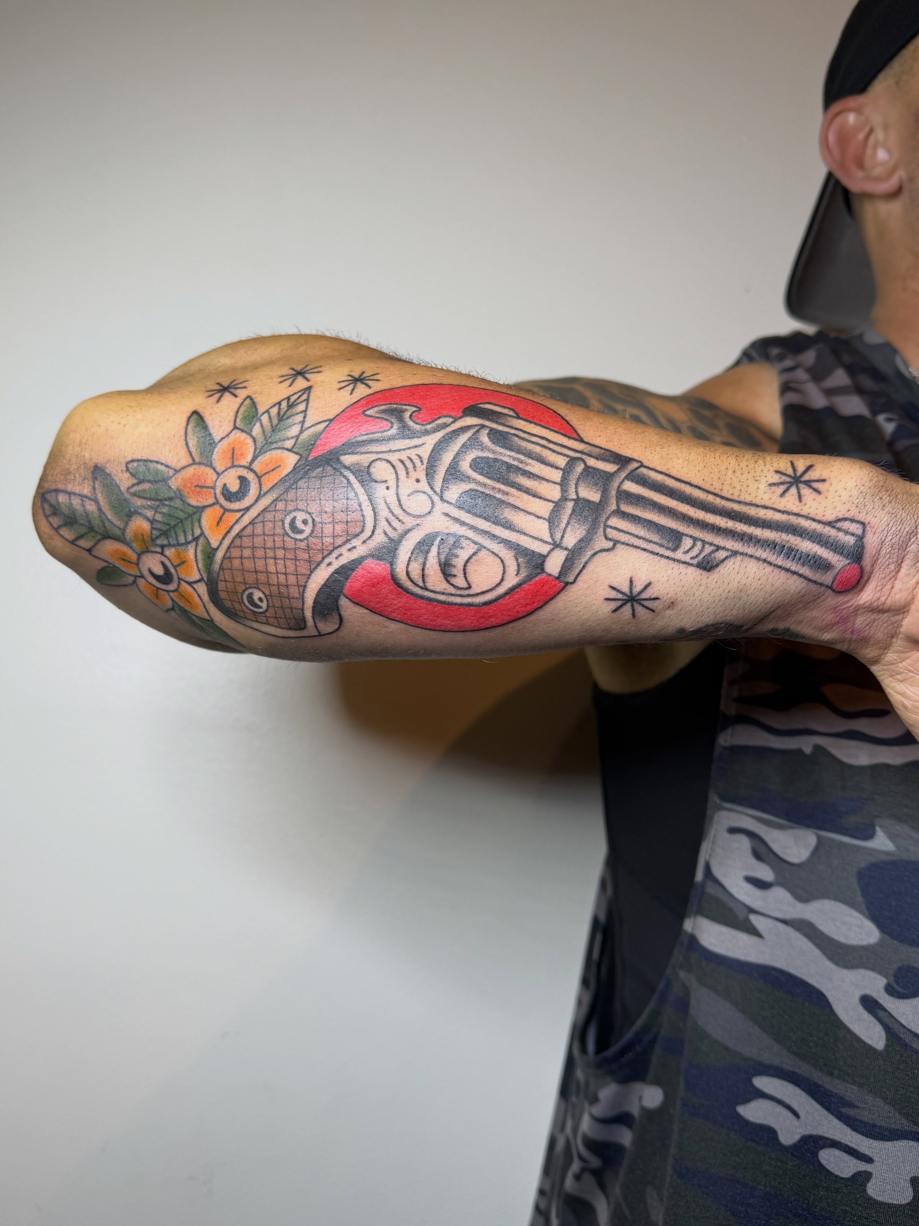 Gun and fish American traditional tattoo on the forearm by Kieara West