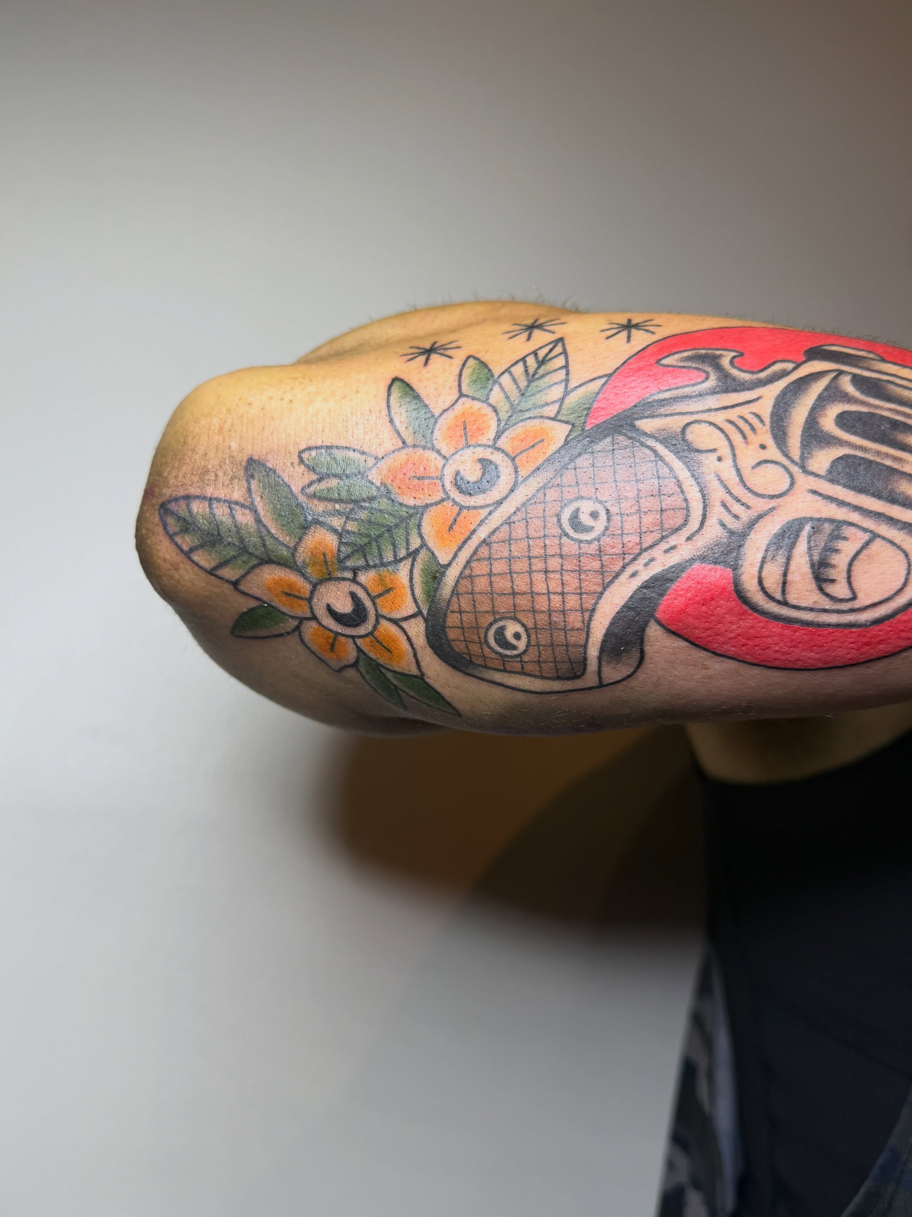 Gun and flowers American traditional tattoo on the forearm by Kieara West