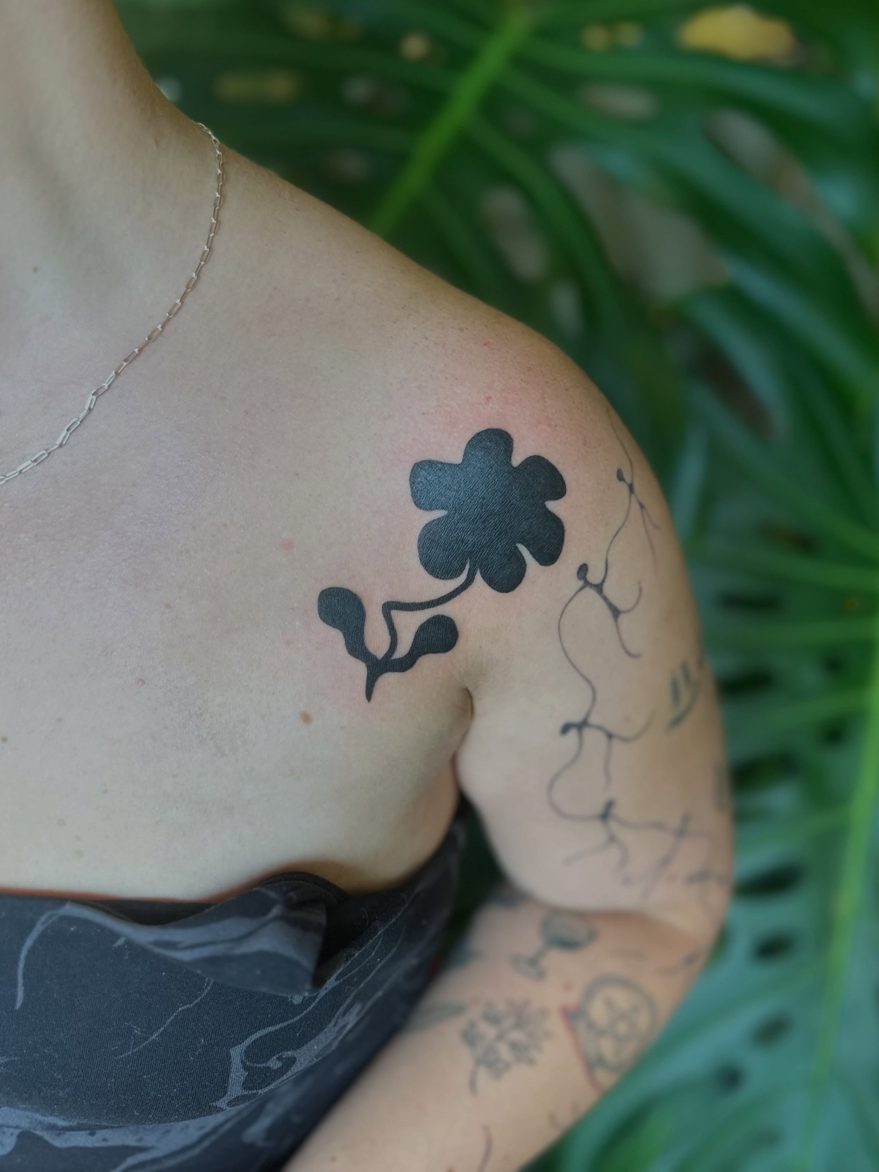 Flower black and grey tattoo on the shoulder by Ransom