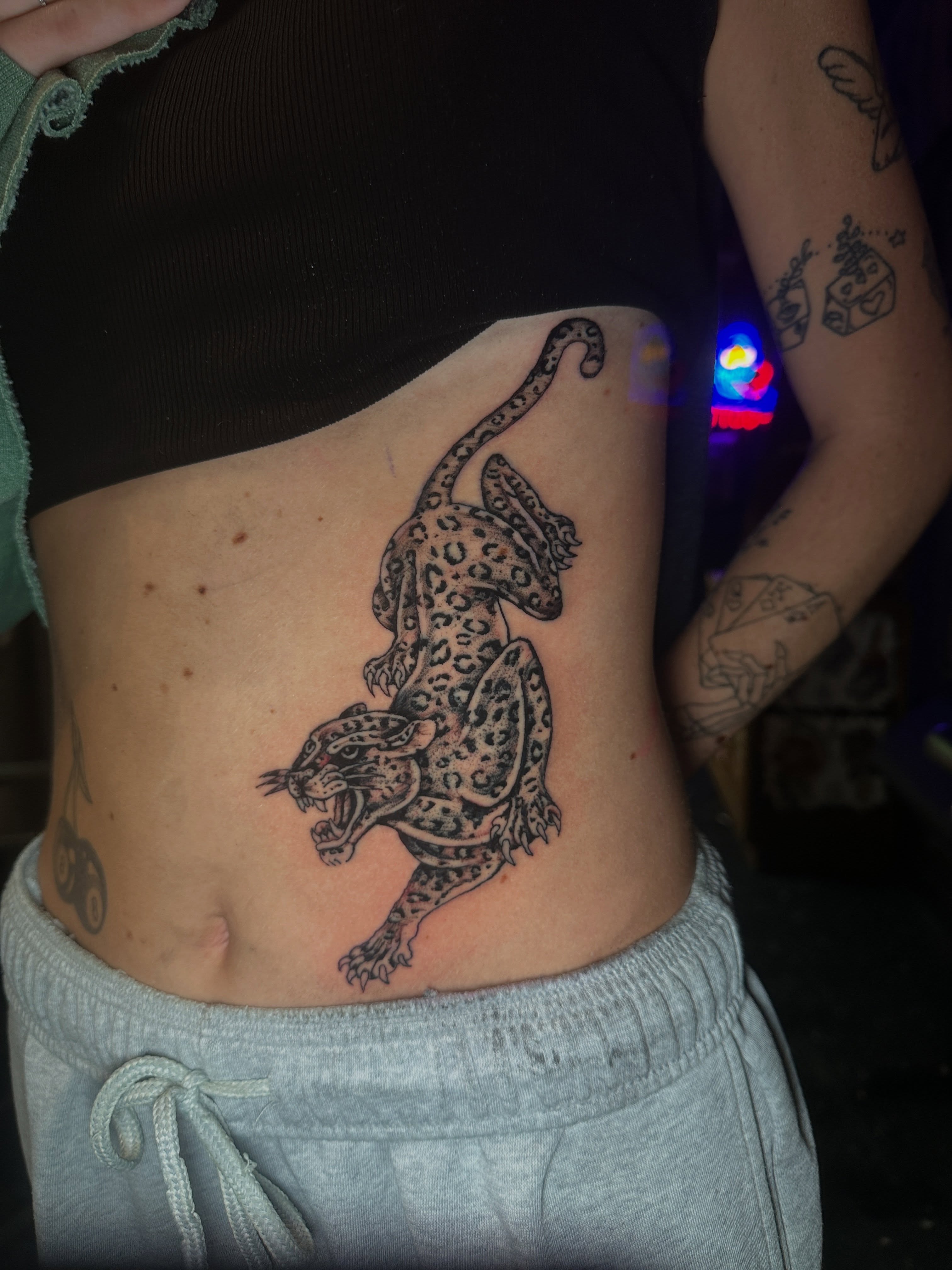 Leopard black and grey tattoo on the torso by Matthew Tattooer Harman