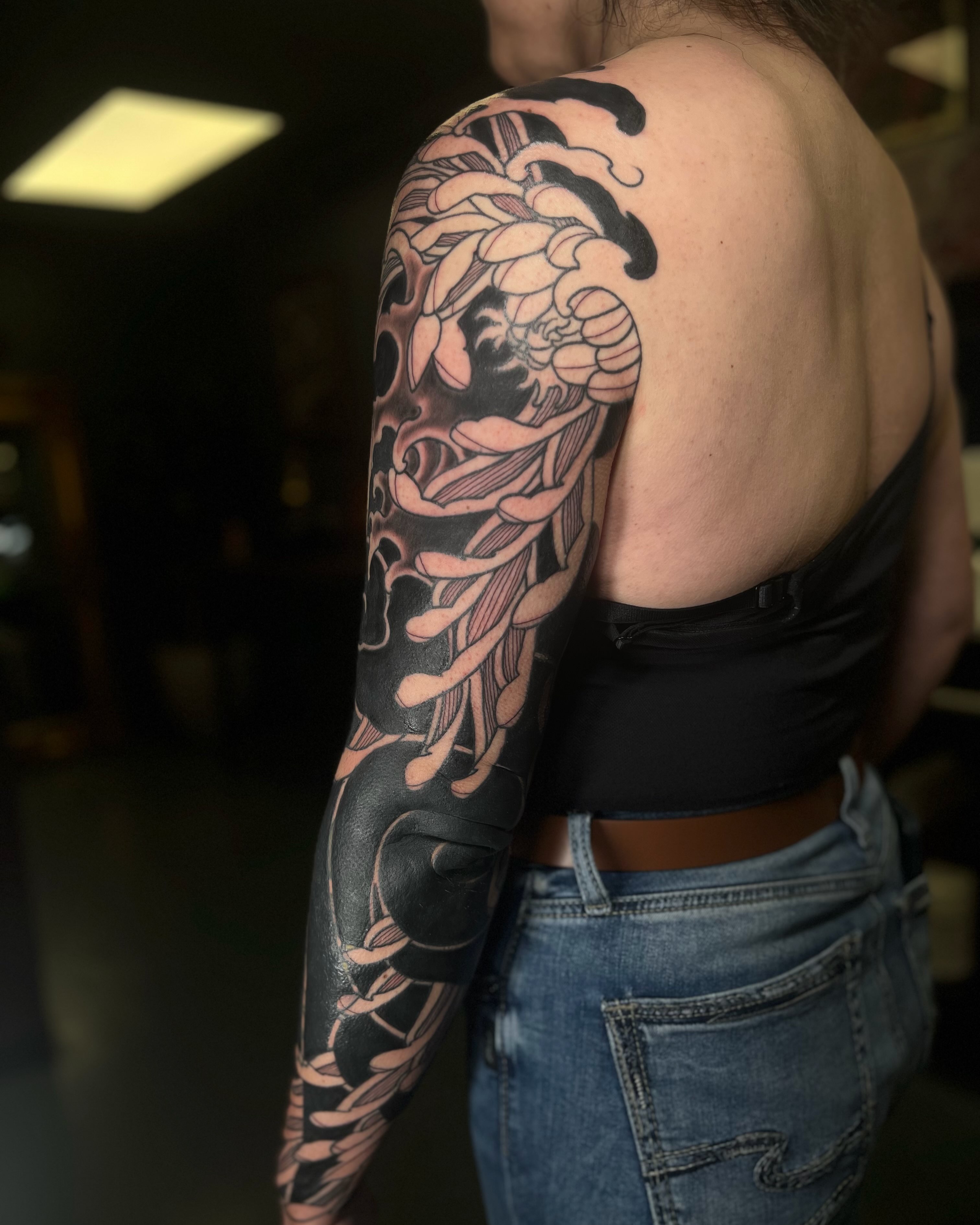 Floral dragon japanese irezumi tattoo on the upper arm by Kaichi Fujita, Eugene, Oregon