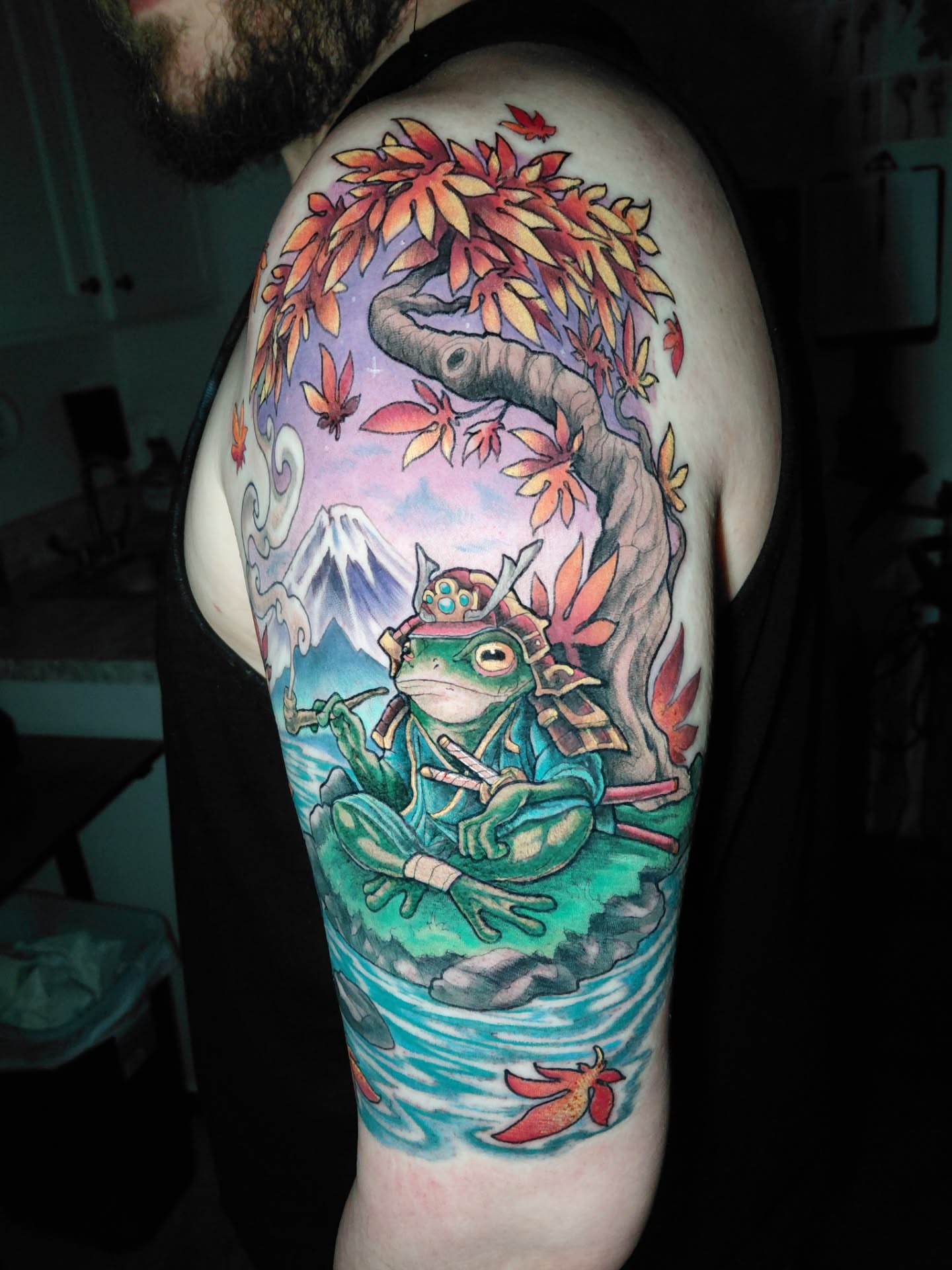 Frog samurai illustrative tattoo on the upper arm by Chris Bowen