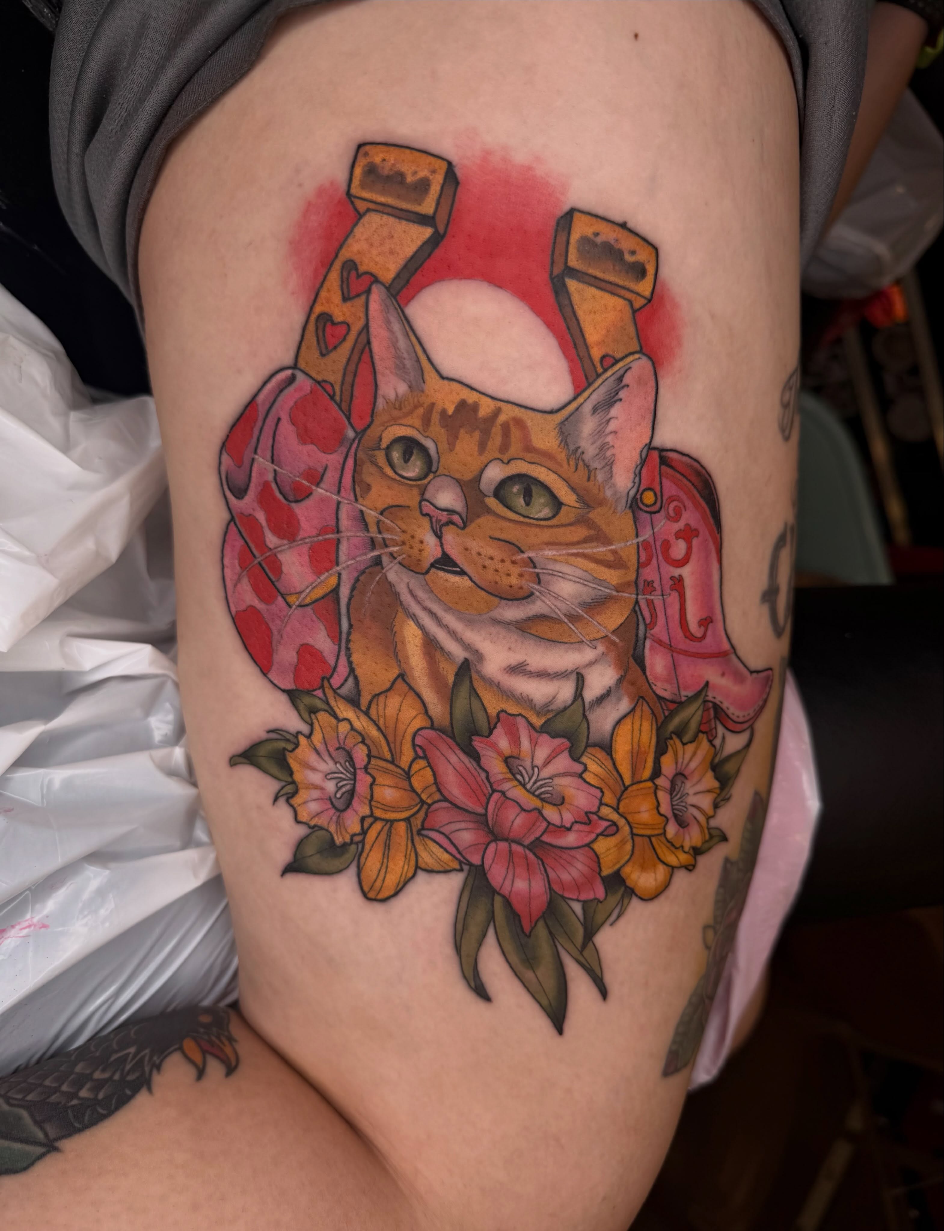 Cat with flowers American traditional tattoo on the thigh by Mika Clairissa