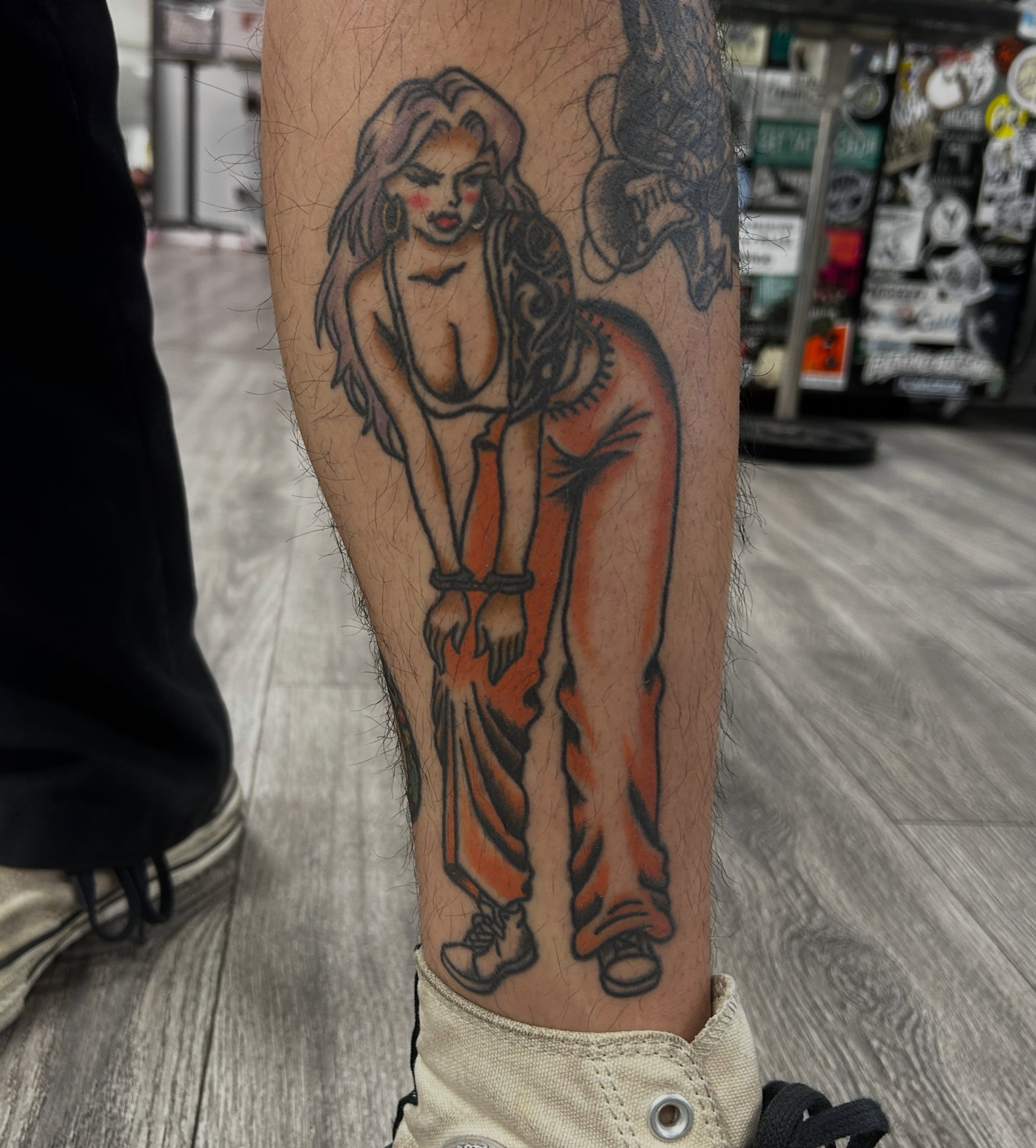 Woman in chains American traditional tattoo on the forearm by Tawni Bender
