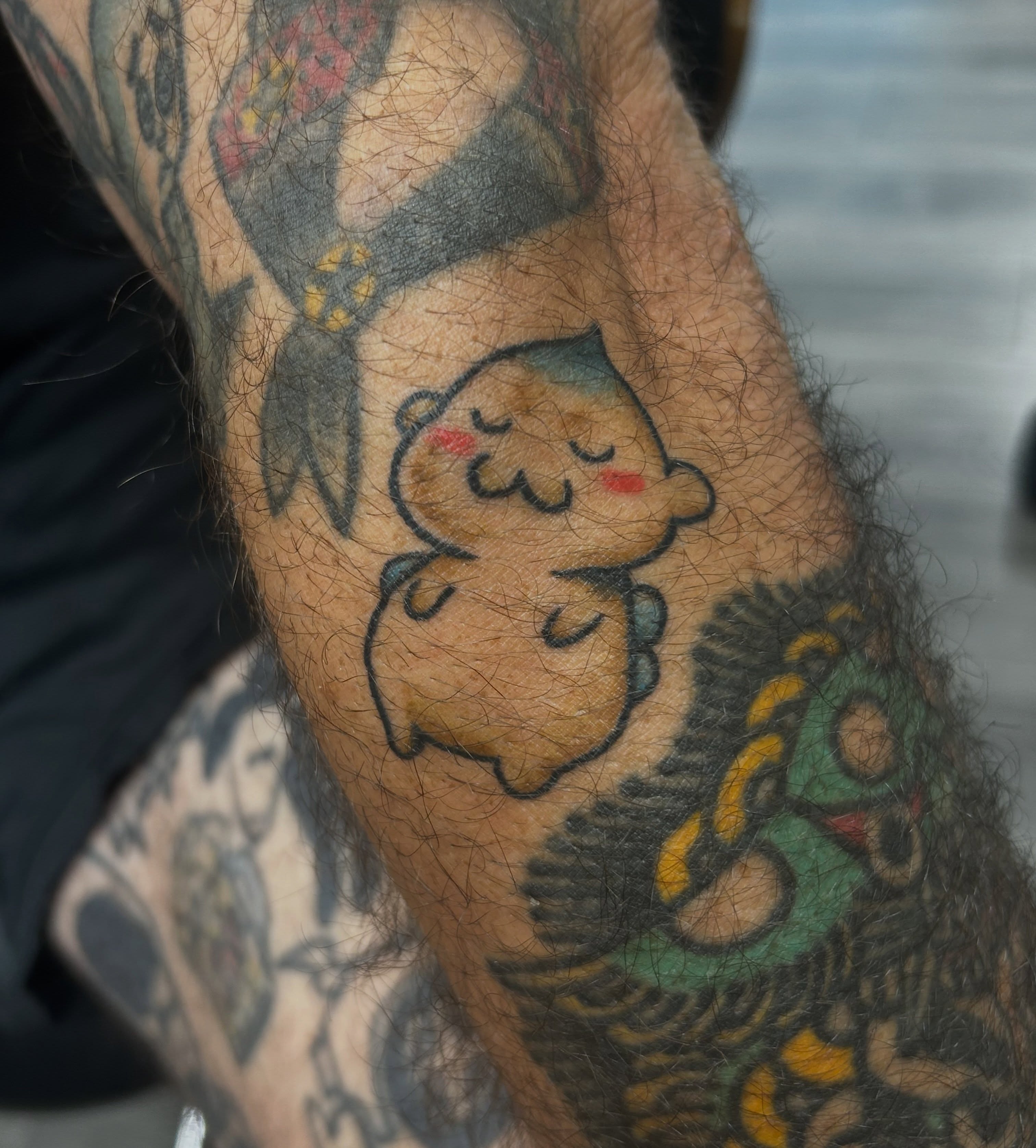 Sleeping bear American traditional tattoo on the forearm by Tawni Bender
