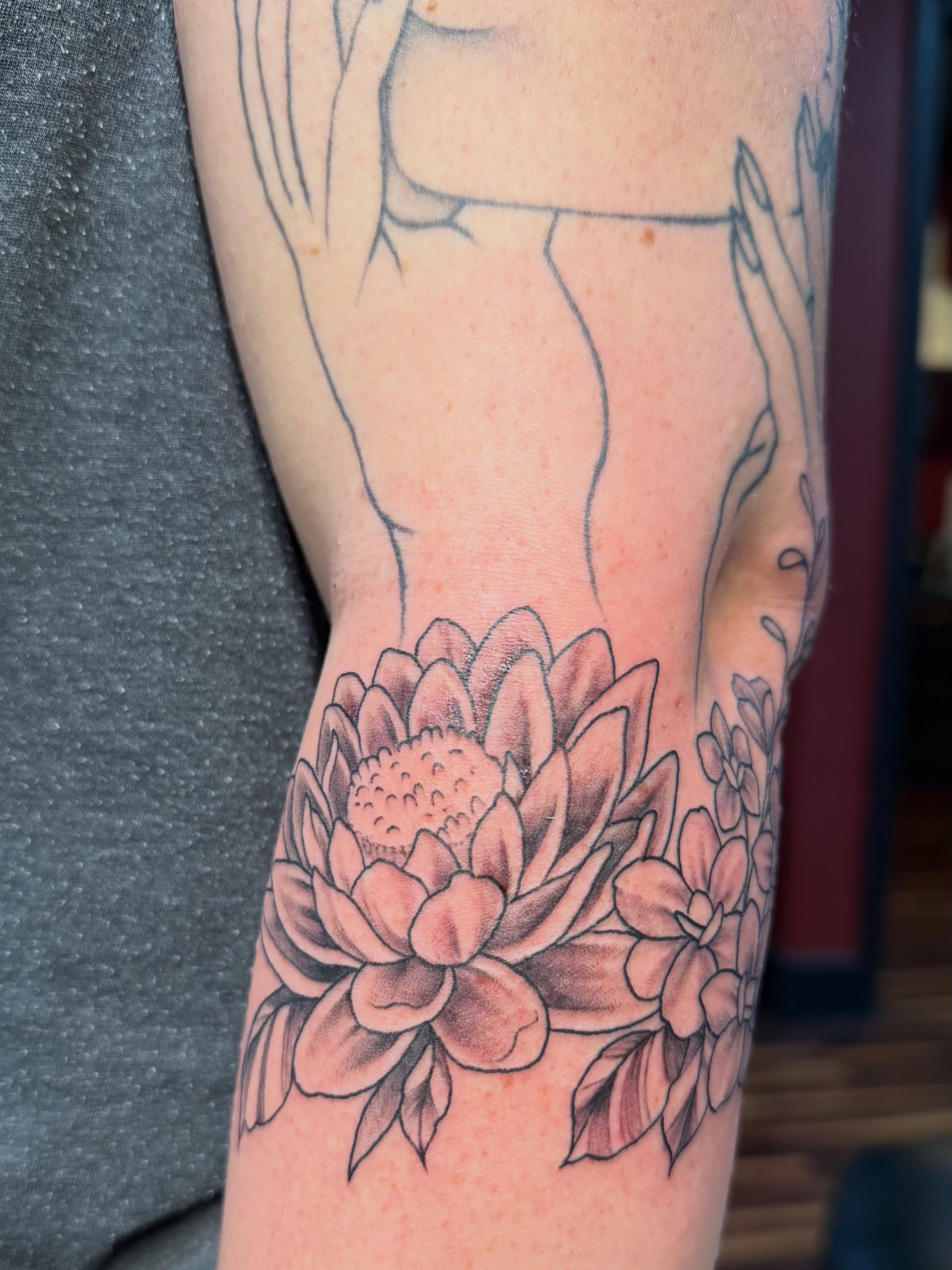 Lotus flower black and grey tattoo on the forearm by TyAnne Schulte