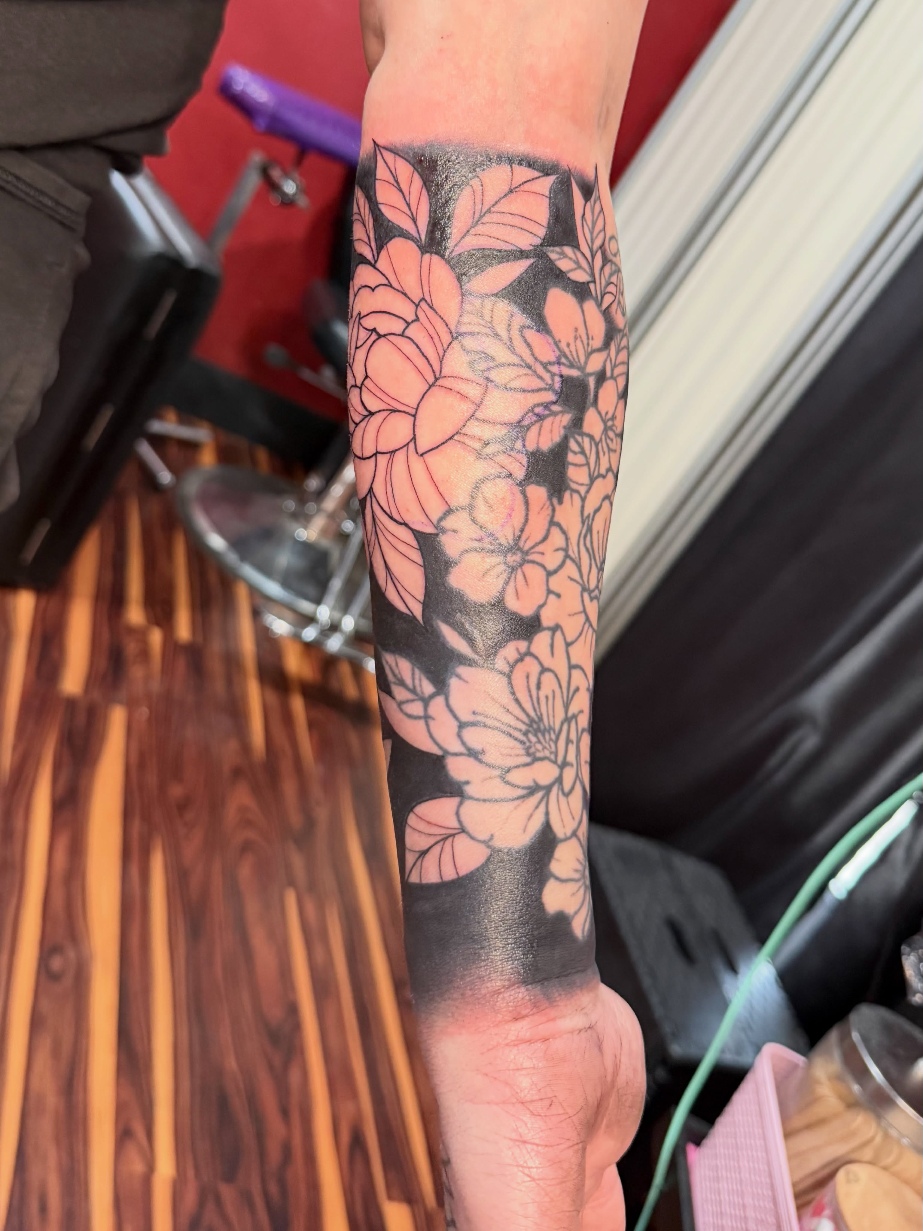 Floral bouquet black and grey tattoo on the forearm by TyAnne Schulte