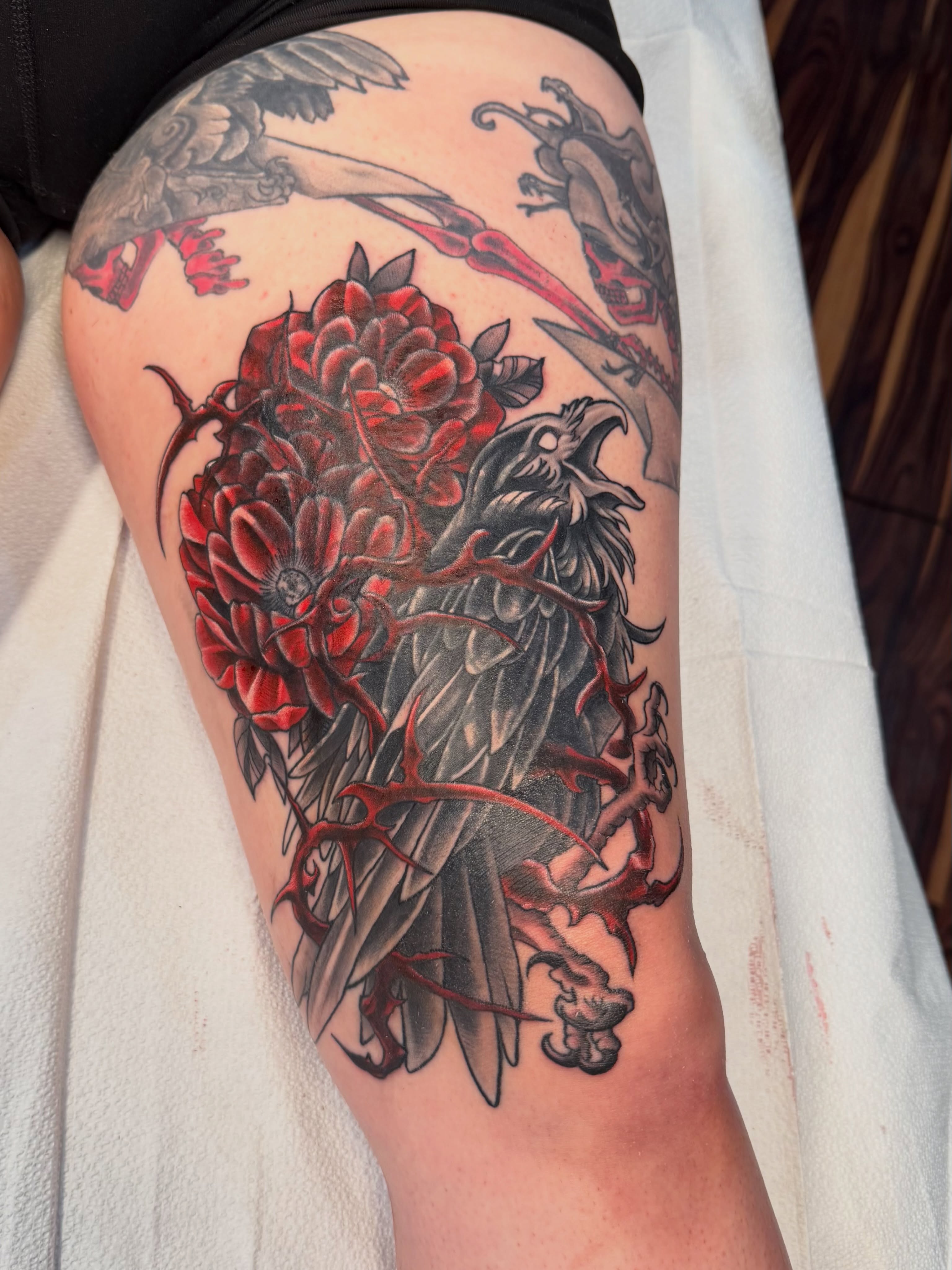 Eagle and flowers American traditional tattoo on the thigh by TyAnne Schulte