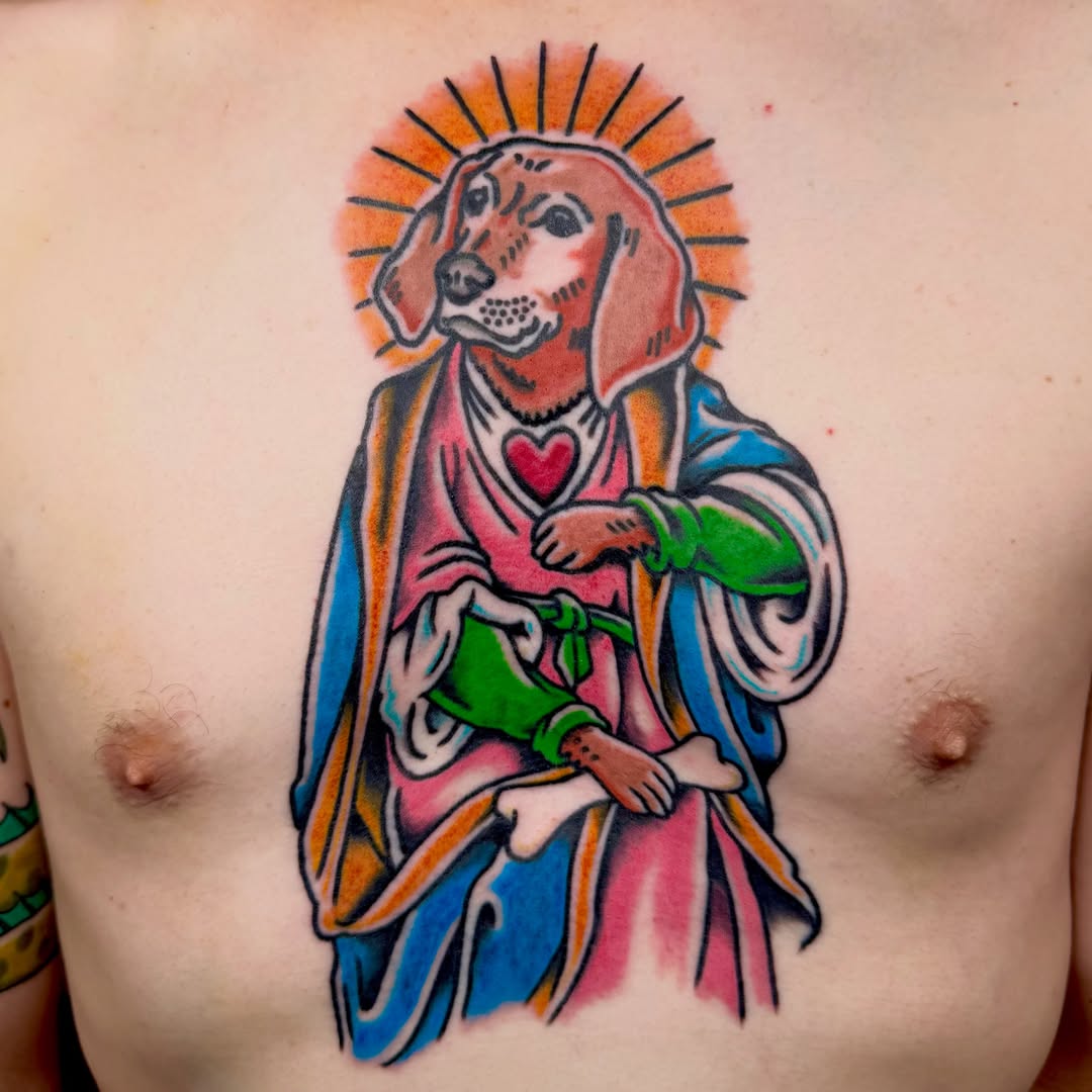 Dog in religious attire American traditional tattoo on the chest by Henry Bubula, Minneapolis, Minnesota