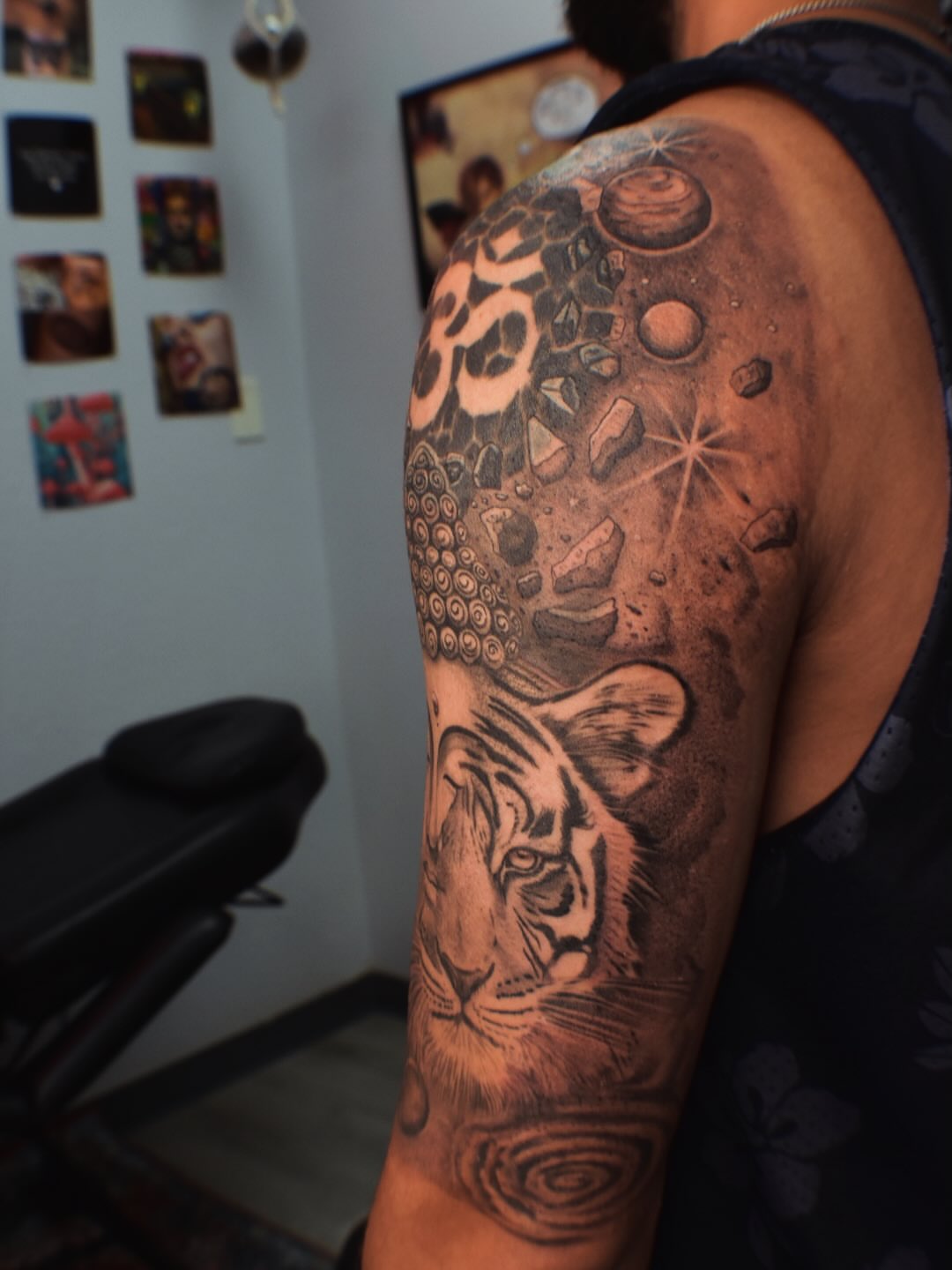 Tiger and celestial elements realism tattoo on the upper arm by Alexandria Gudiel