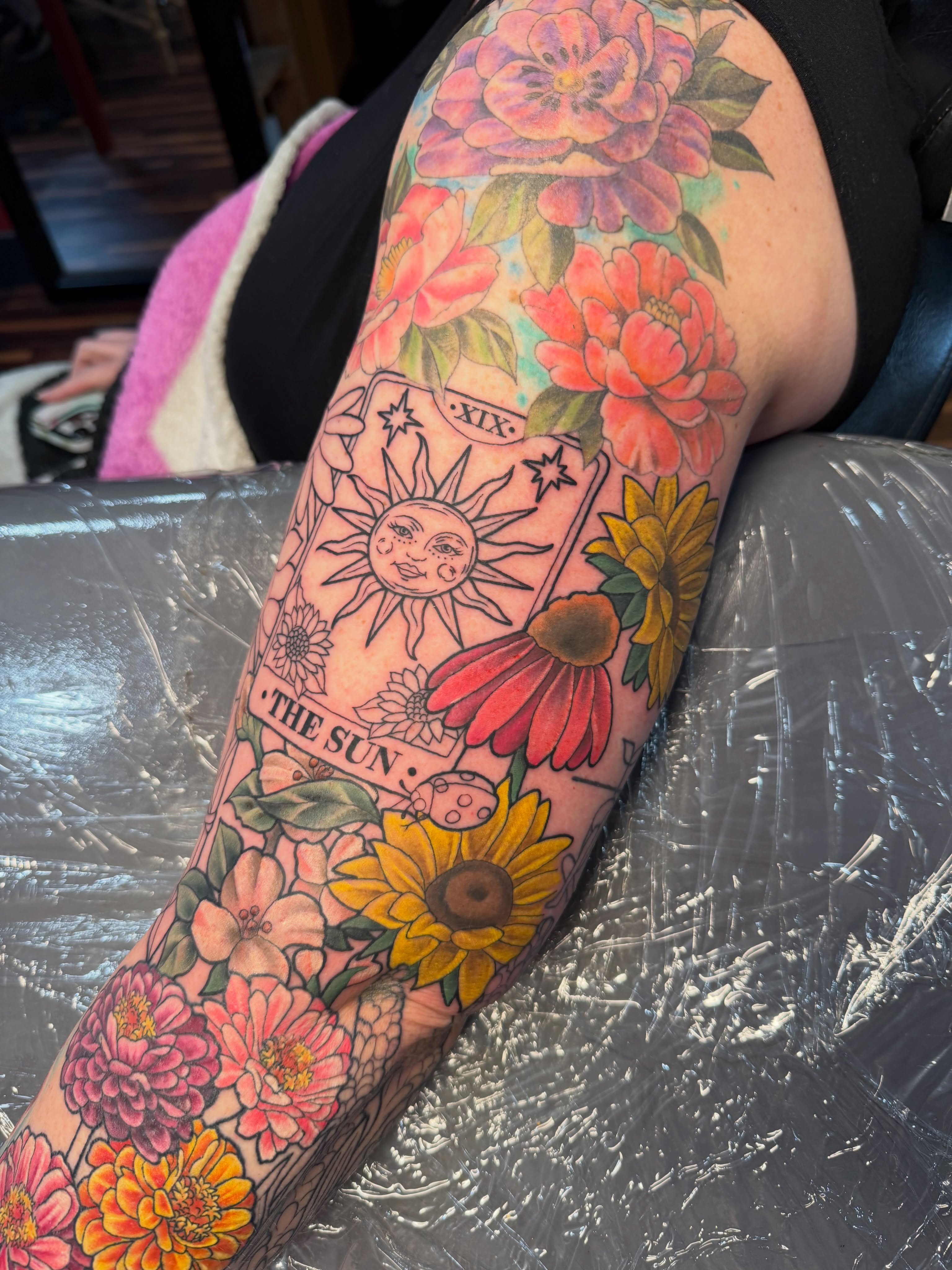 The sun tarot card new school tattoo on the forearm by TyAnne Schulte