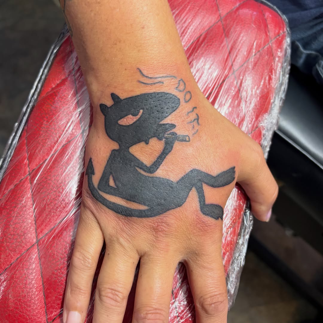 Cat black and grey tattoo on the hand by Vudu Tattooer