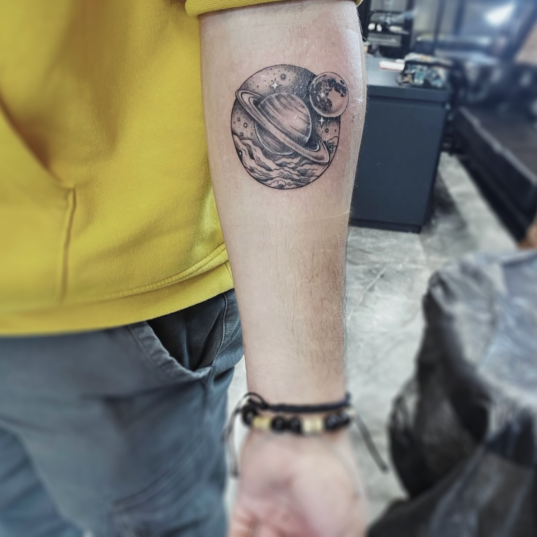 Planets black and grey tattoo on the forearm by R o s e