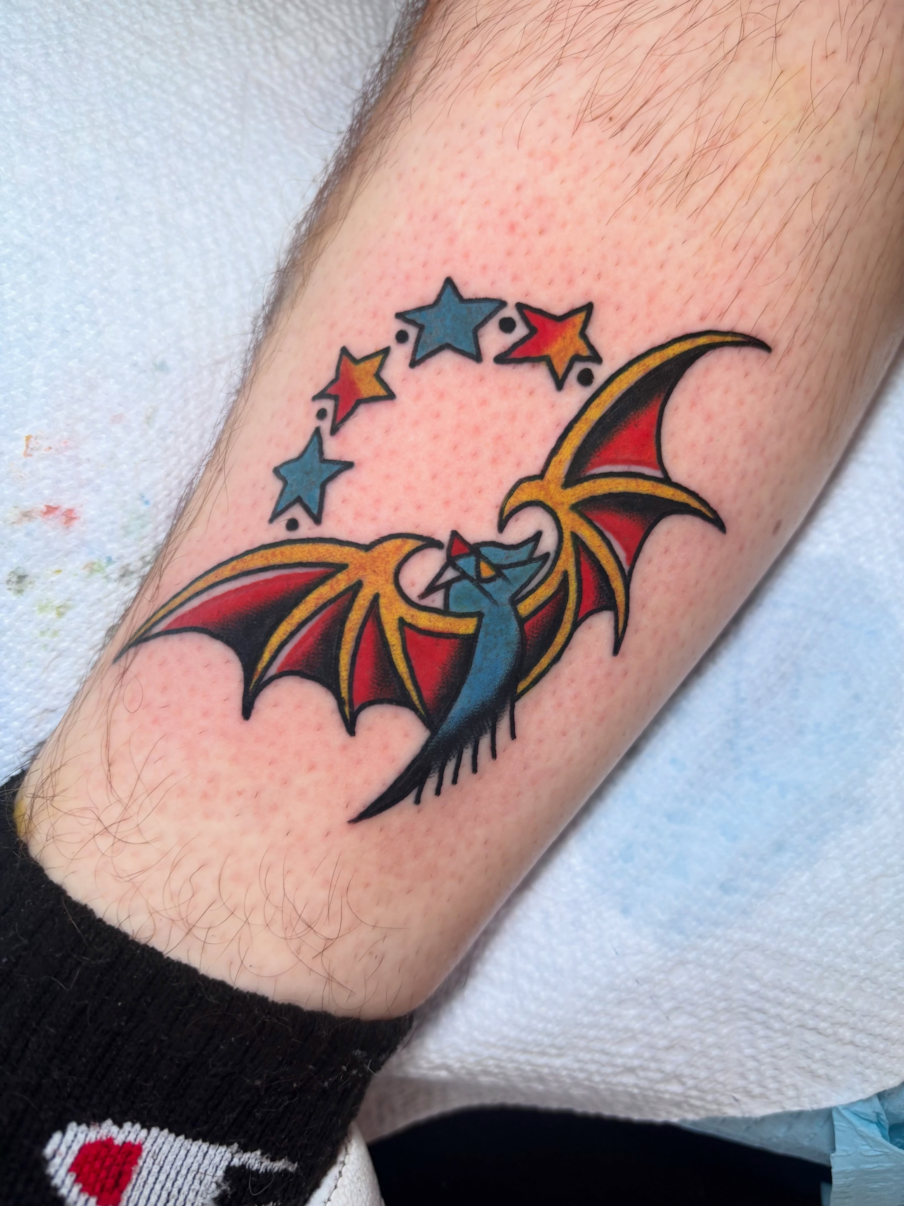 Bat and stars American traditional tattoo on the forearm by Nick