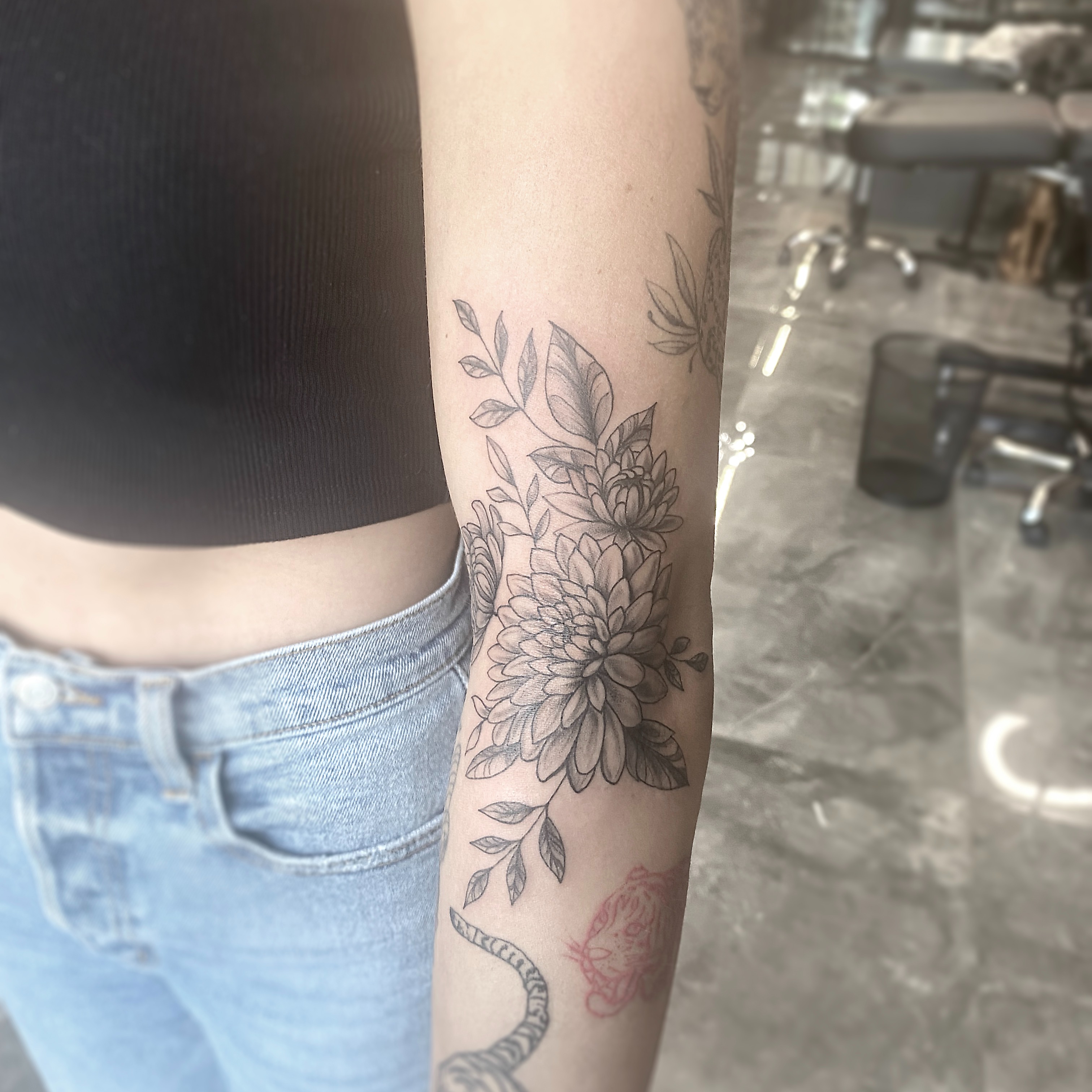 Floral bouquet black and grey tattoo on the forearm by R o s e