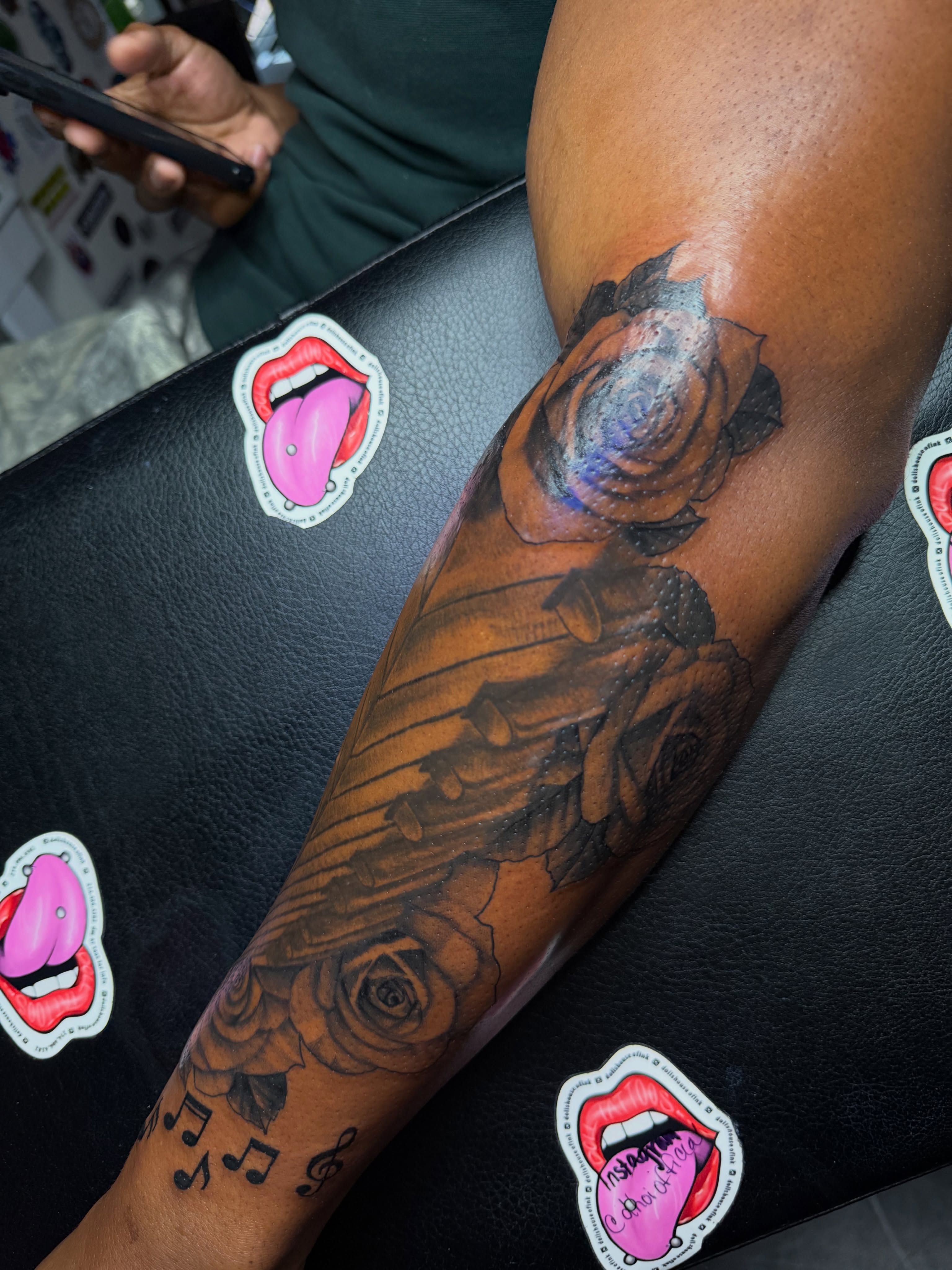 Roses and guitar realism tattoo on the forearm by Doll The Tattoo Artist, Addison, Texas