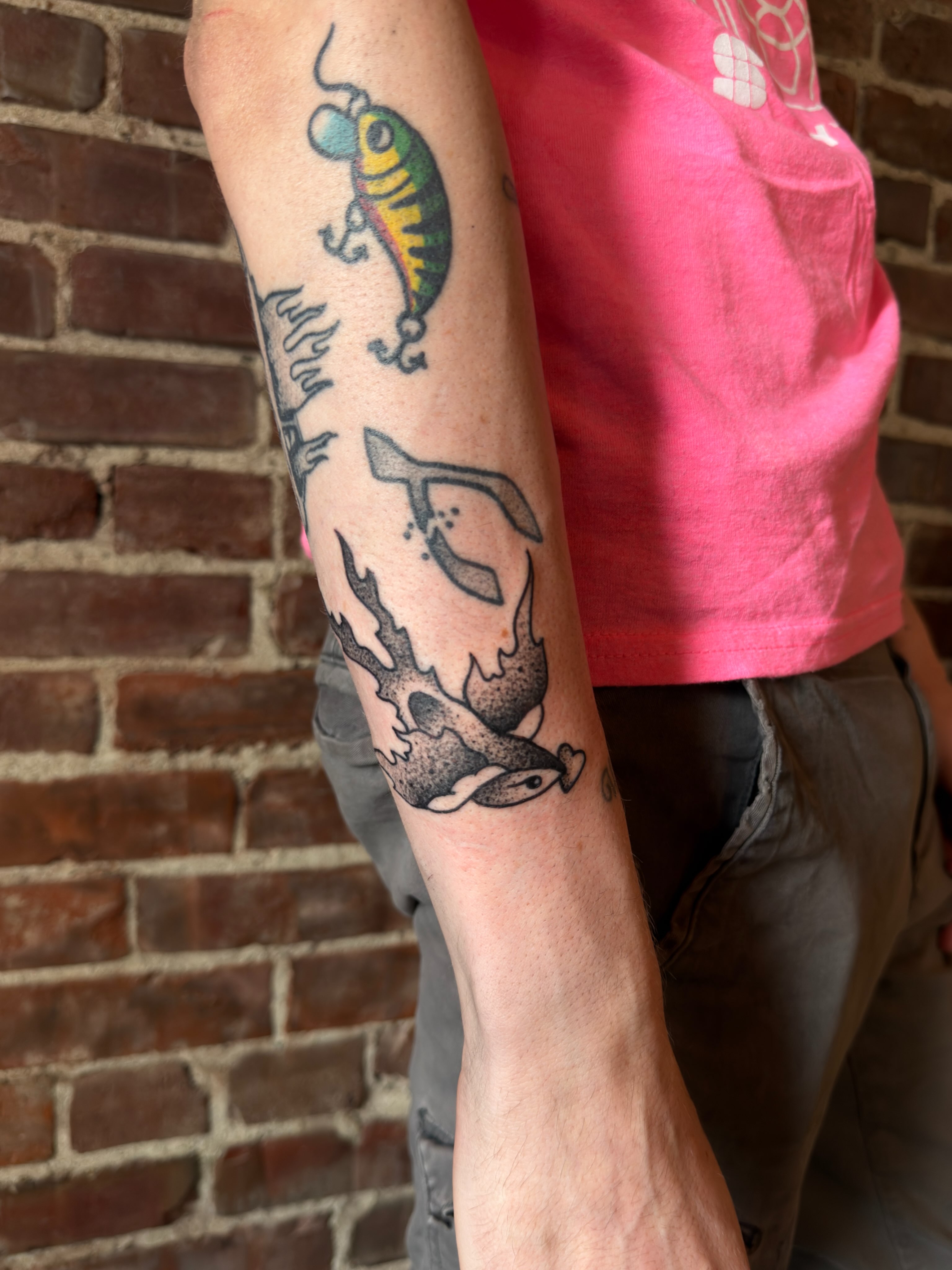 Lure and fish American traditional tattoo on the forearm by Dennis Patterson