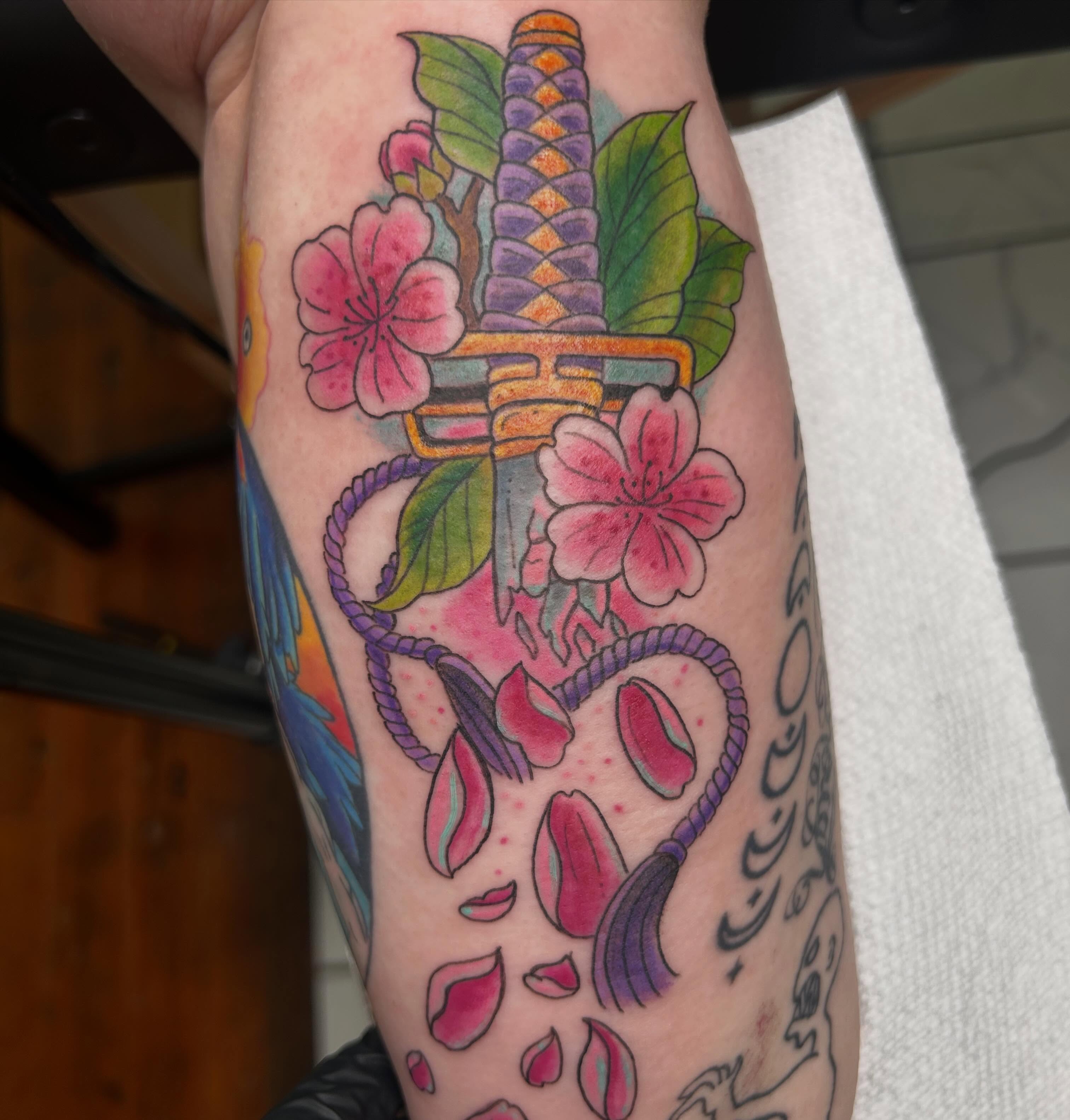 Cherry blossoms and katana American traditional tattoo on the forearm by Reilley Earles