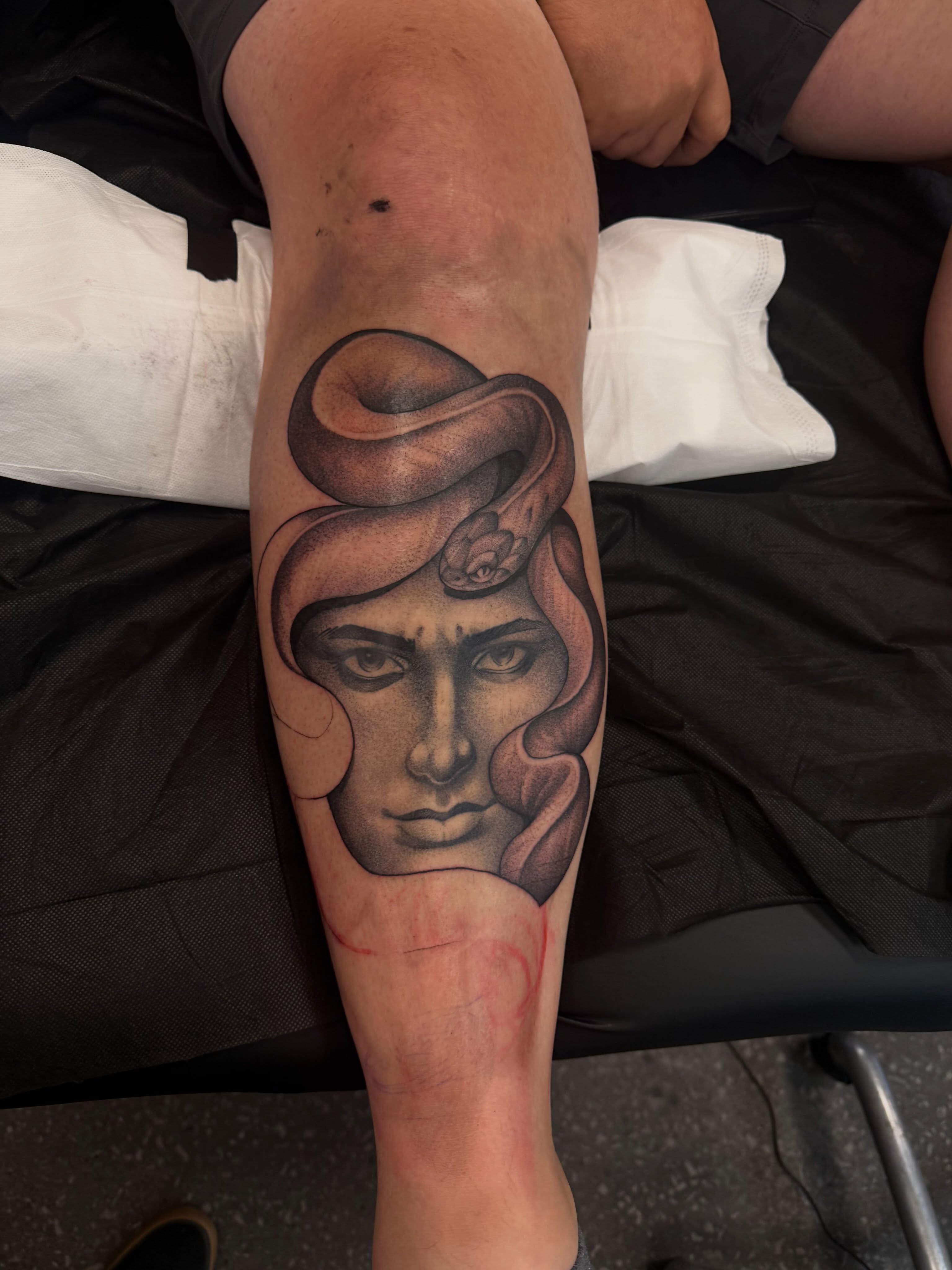 Woman's head with snake realism tattoo on the forearm by Will Campbell