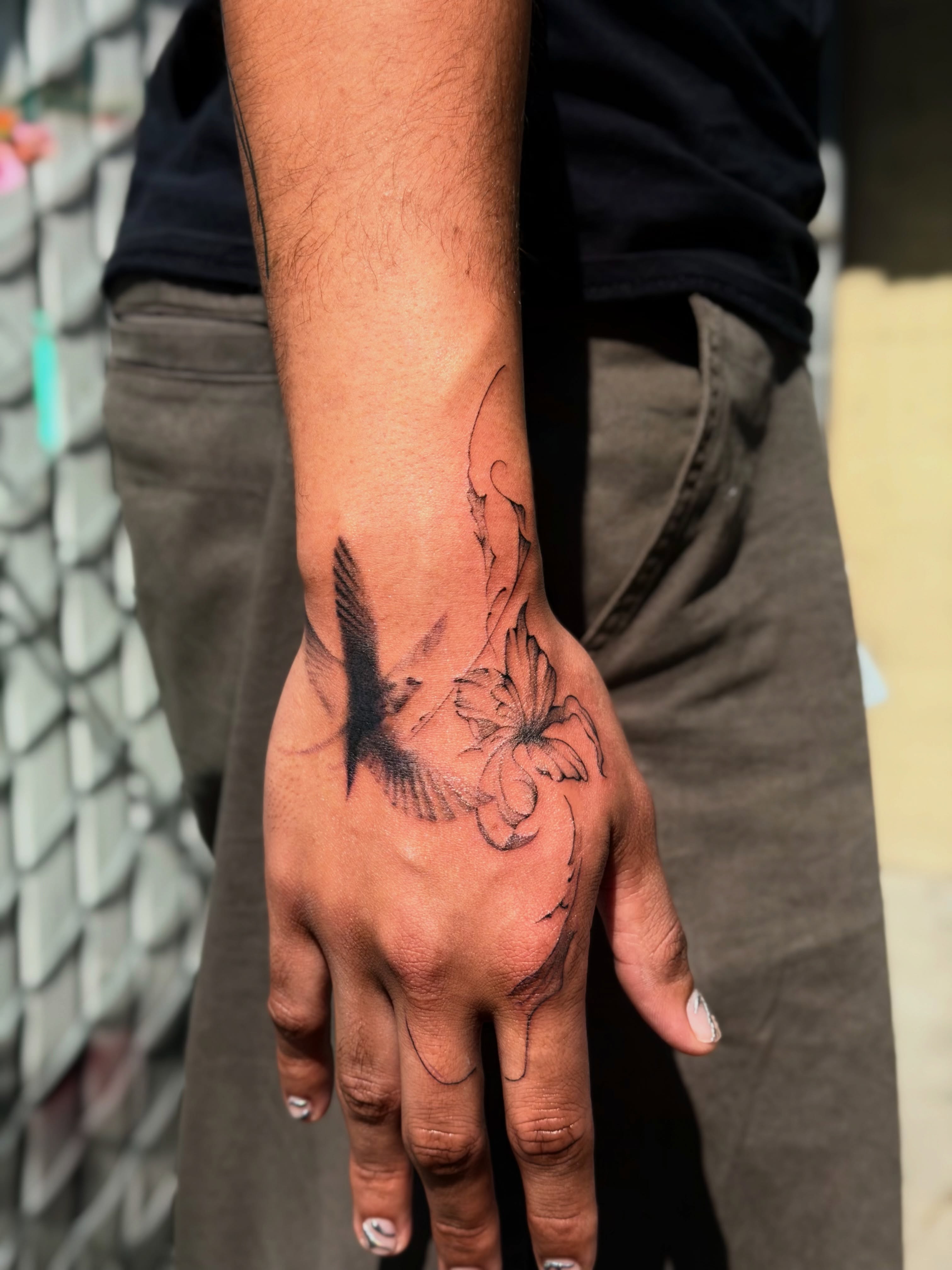 Flower black and grey tattoo on the hand by Bryan Nguyen