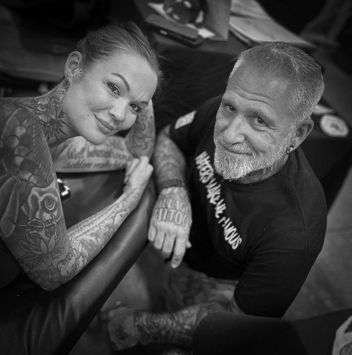 Tattoo artist and client black and grey tattoo on the upper arm by Andres Flores