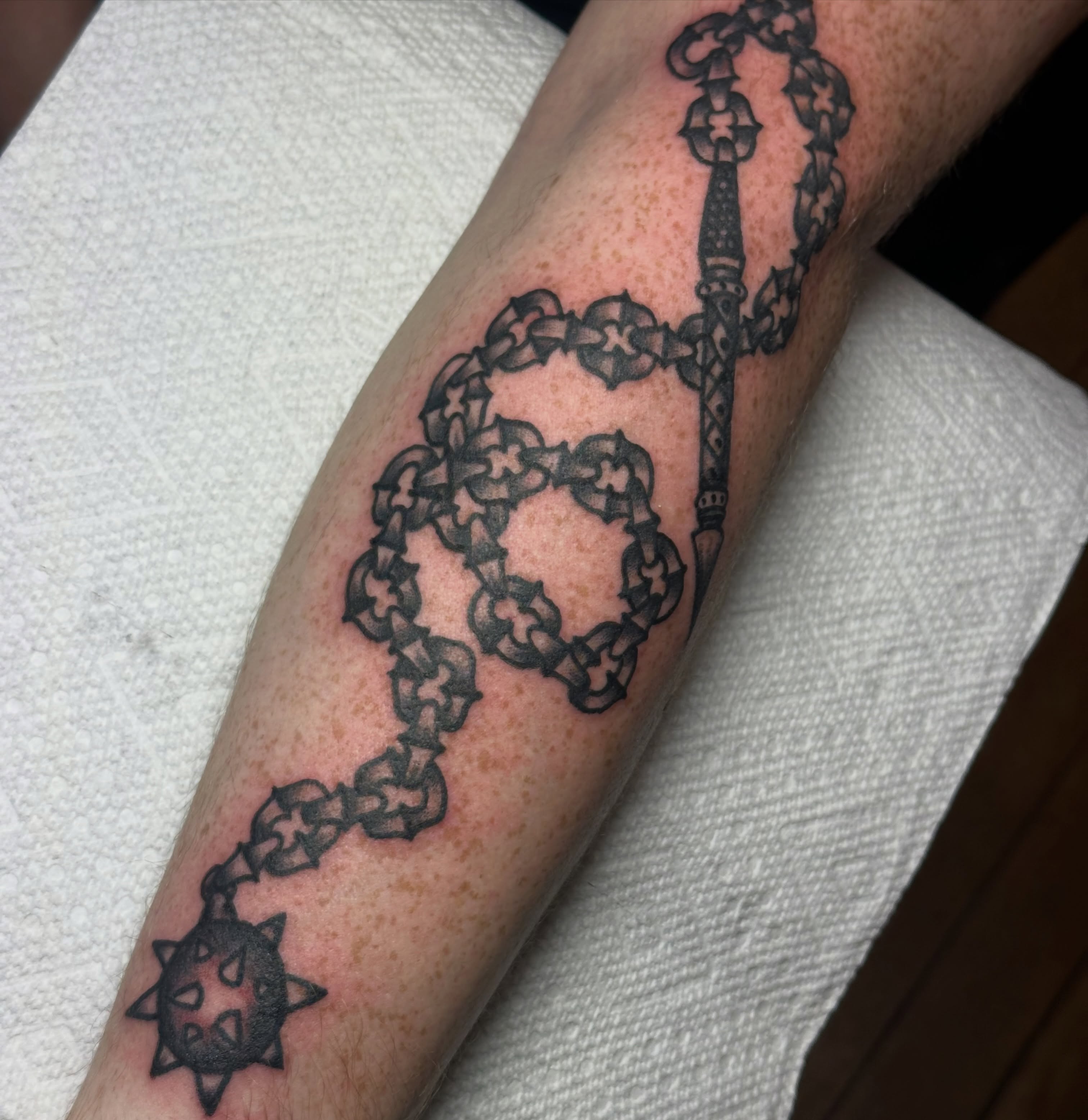 Chain black and grey tattoo on the forearm by Providence Tattooer