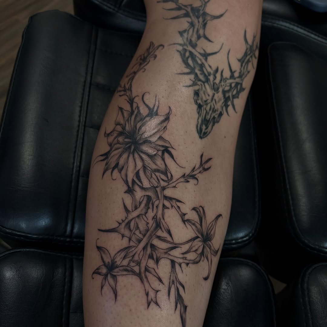 Deer and flowers realism tattoo on the forearm by Cincinnati Tattoo Artist