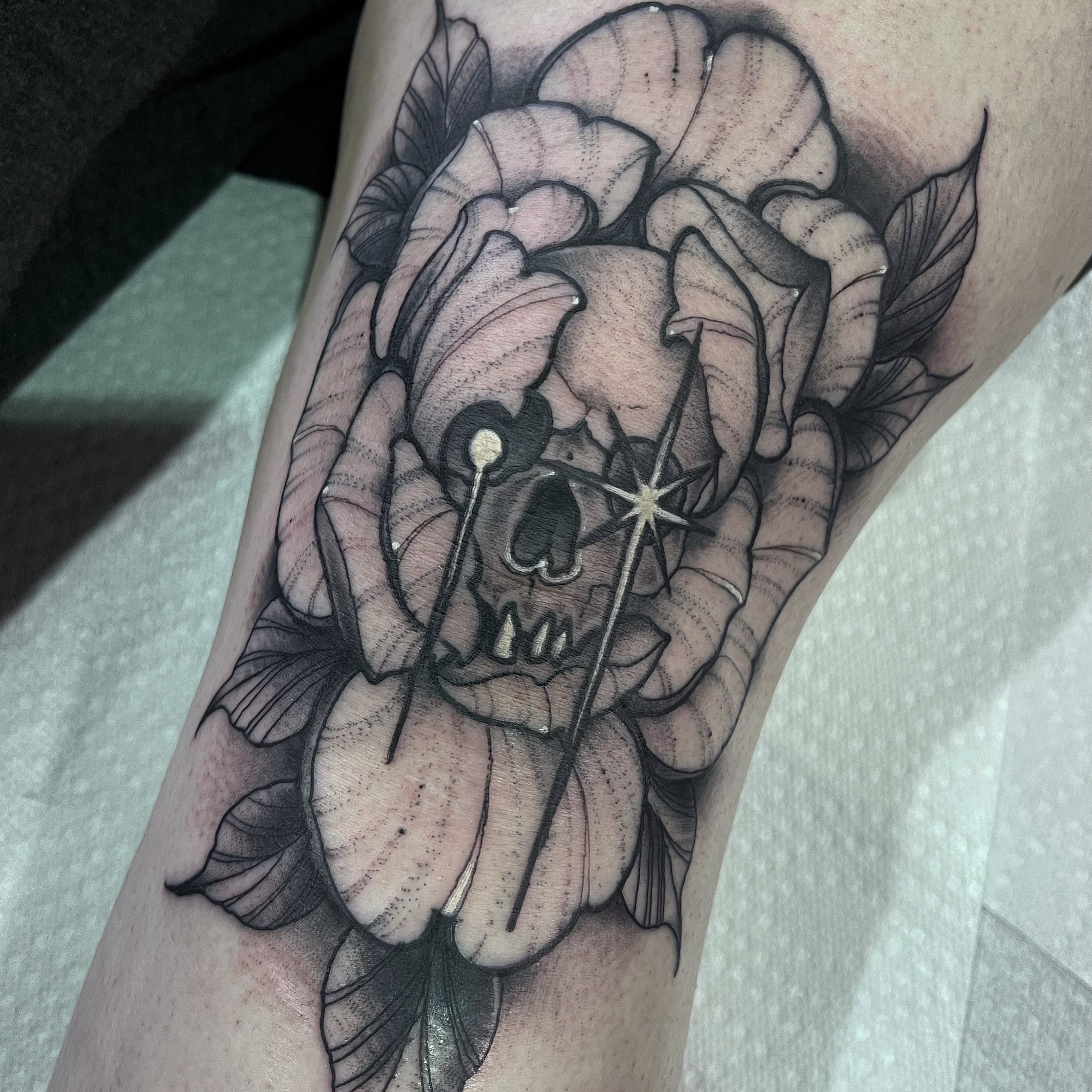 Skull and flower realism tattoo on the forearm by Brandon Mola, Chicago, Illinois