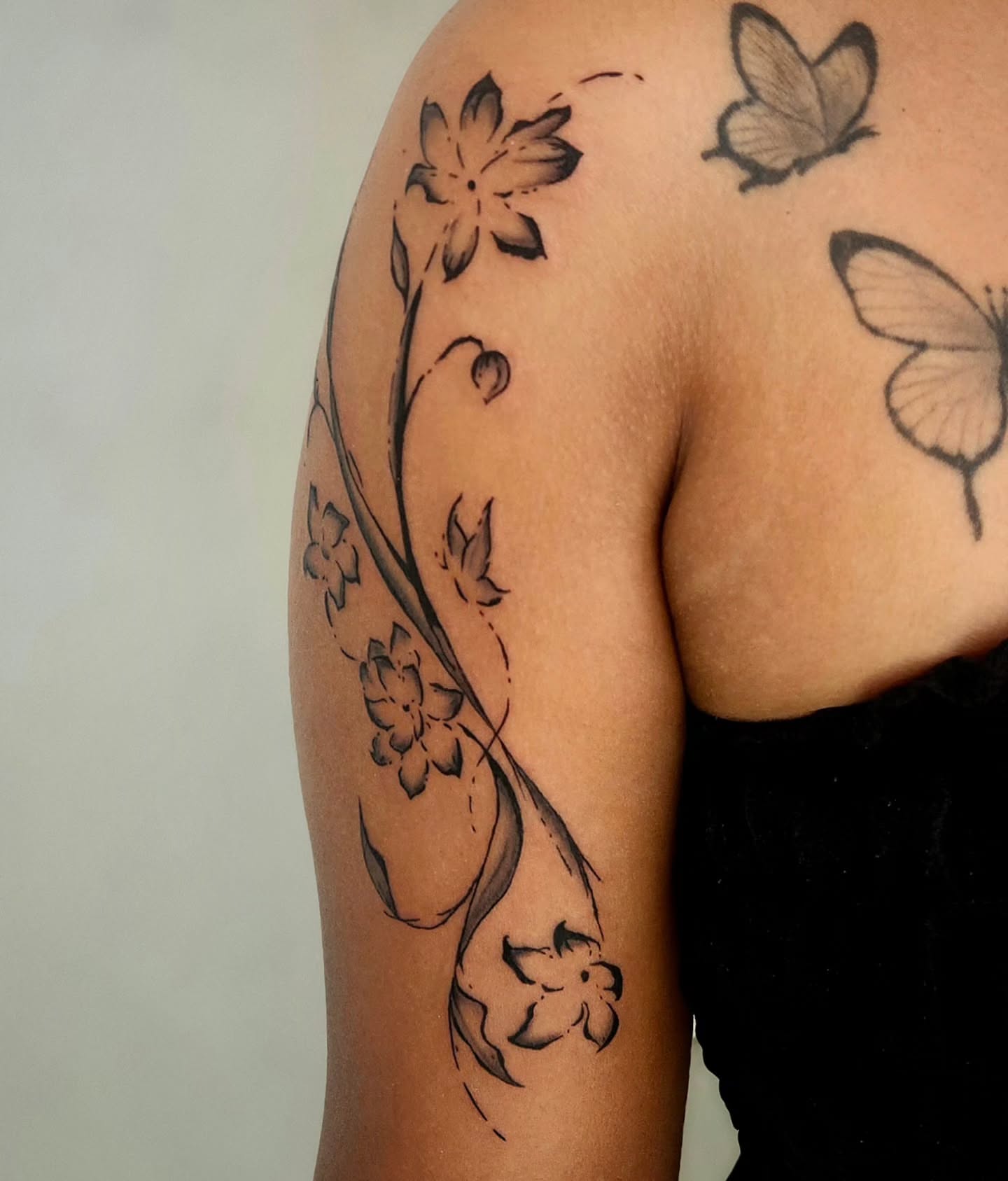 Floral design black and grey tattoo on the shoulder by Lina ๐ป
