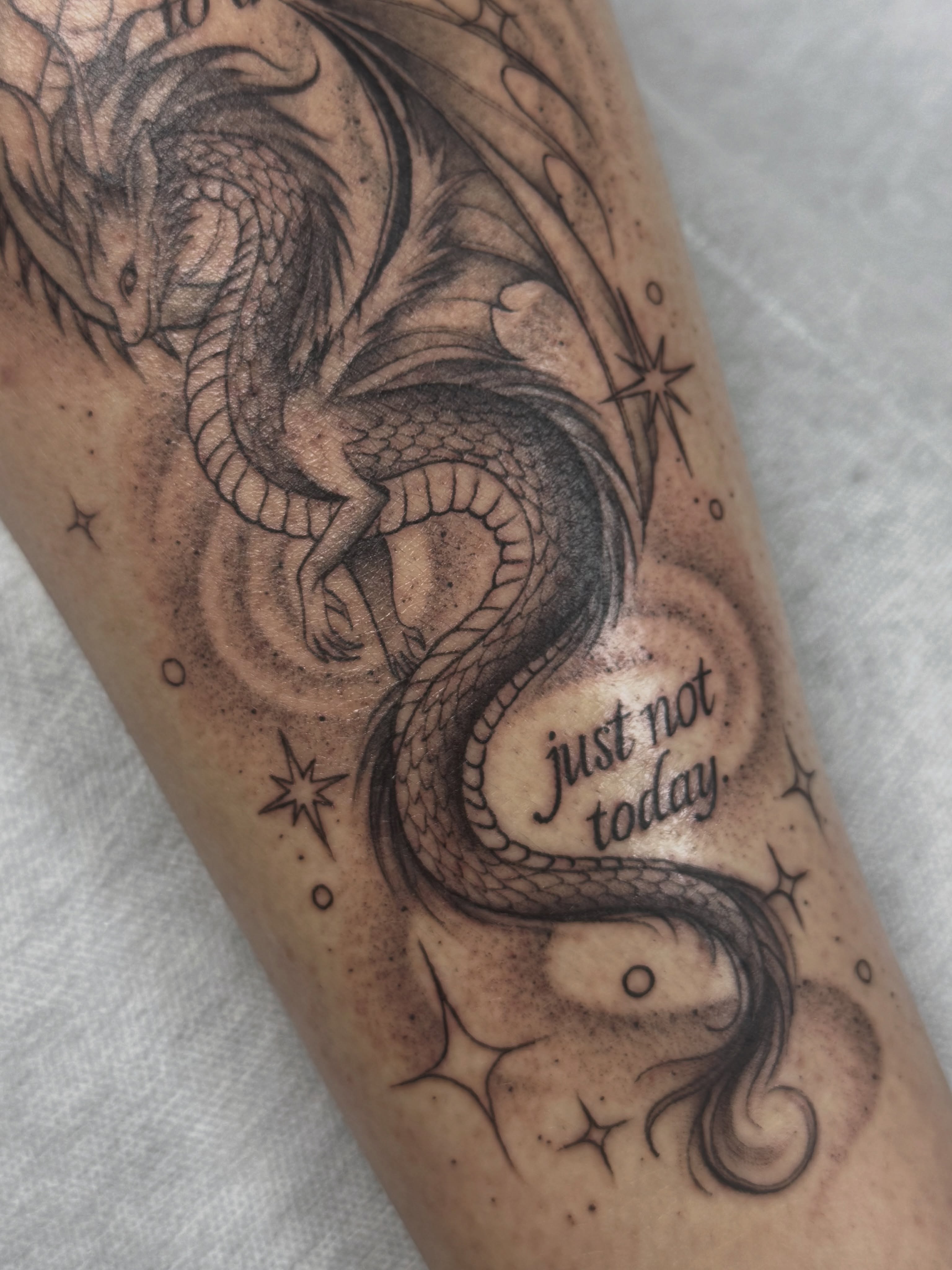 Dragon black and grey tattoo on the forearm by Mo Dinero🎰