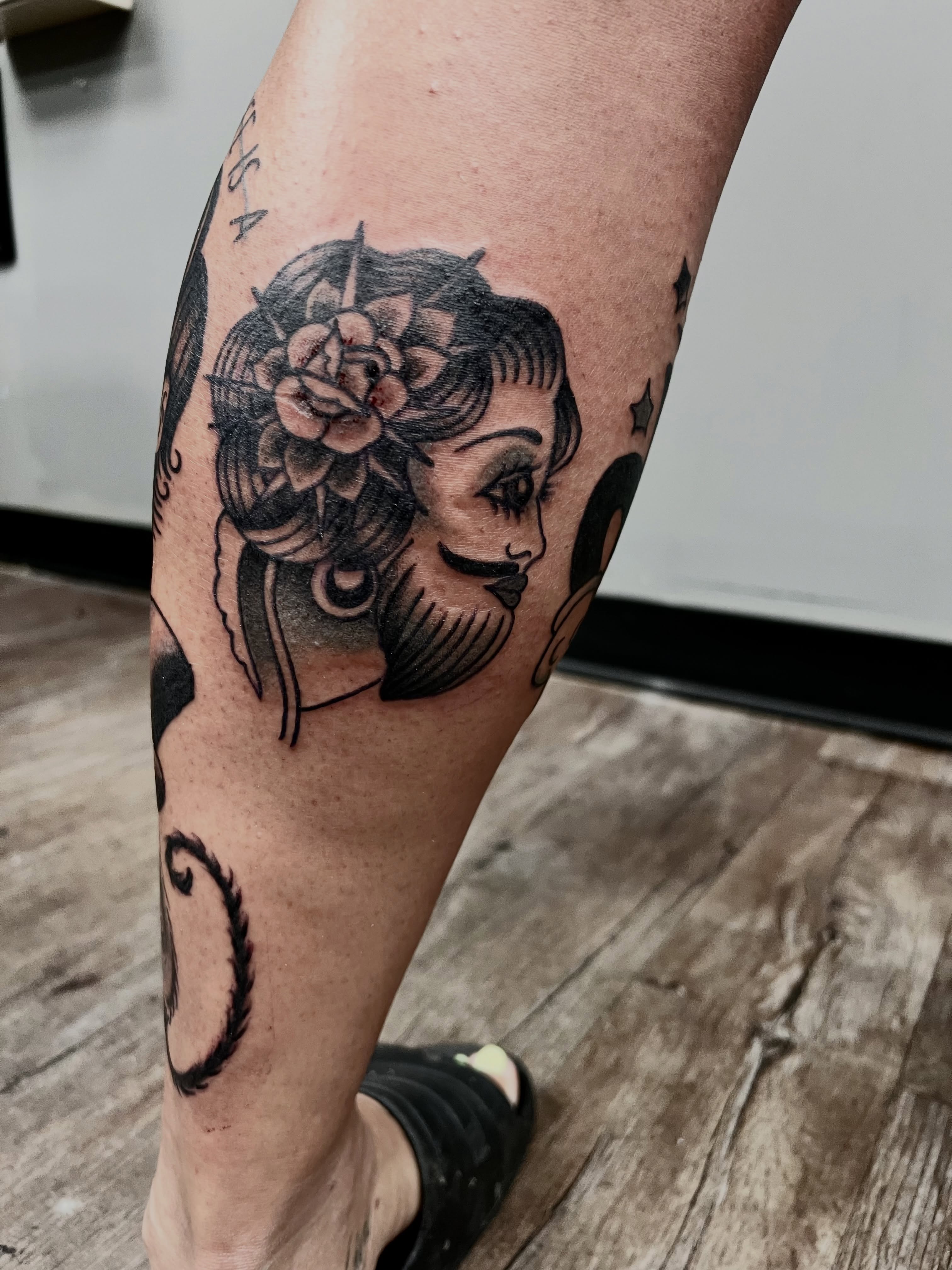 Woman with flower crown American traditional tattoo on the forearm by Josh Kronauer