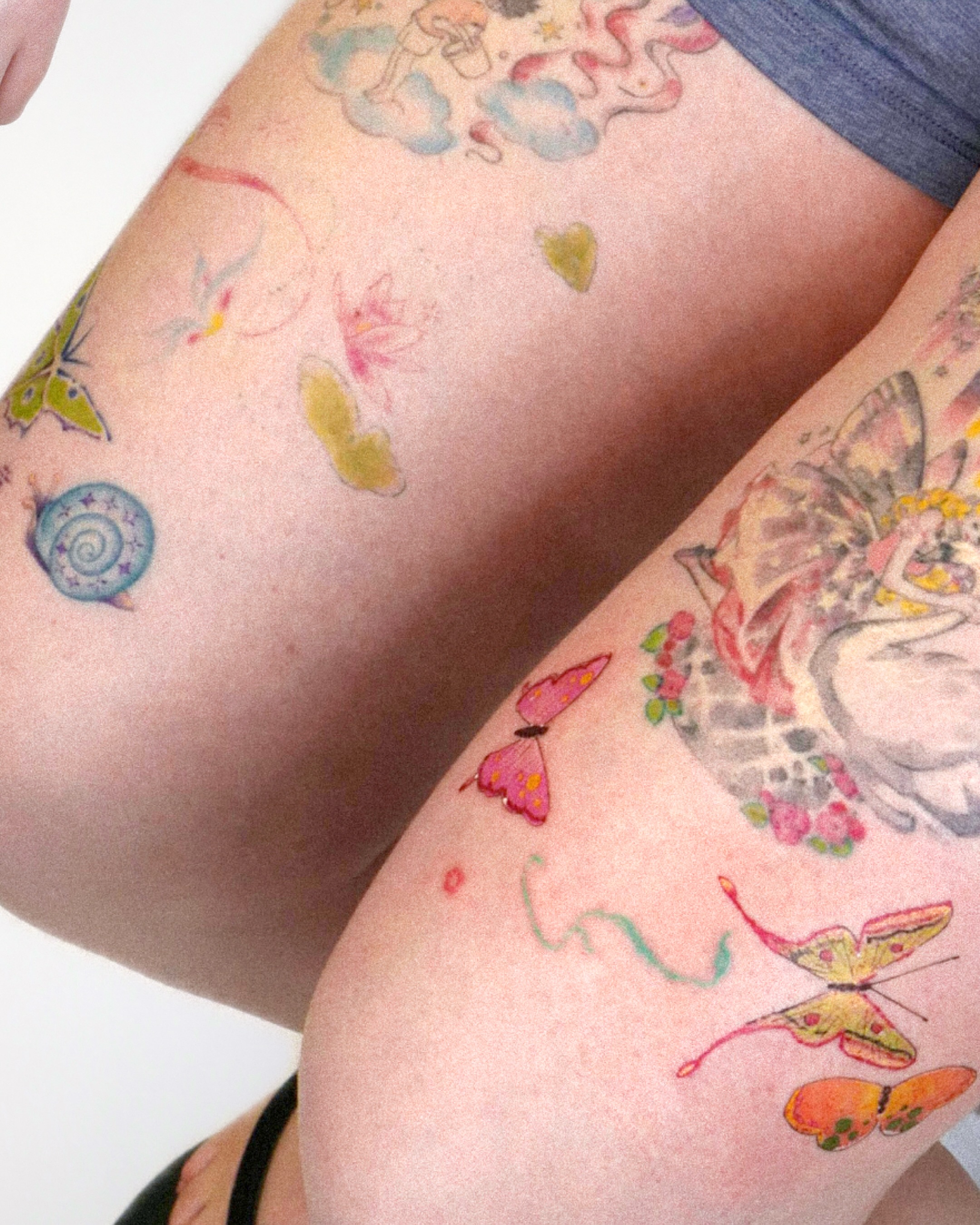 Butterflies and flowers watercolor tattoo on the thigh by dahye lee