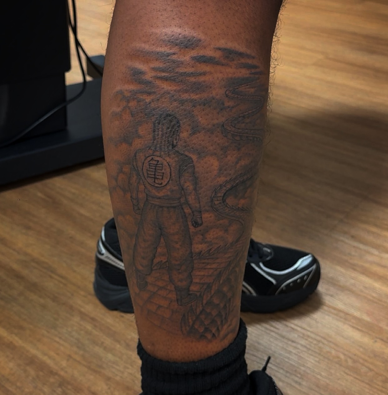 Dragon ball character black and grey tattoo on the forearm by Royal Martinez