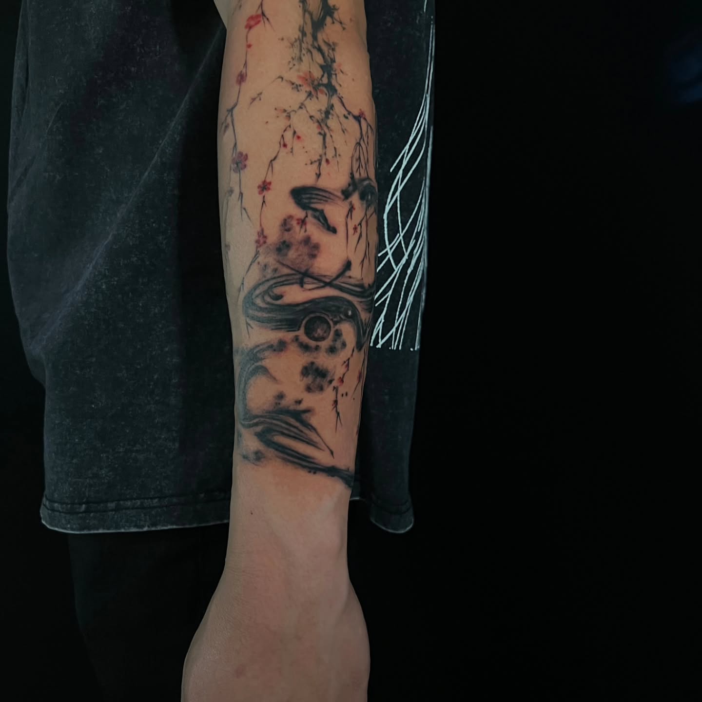 Cherry blossoms and bird dotwork tattoo on the forearm by Lili Gu
