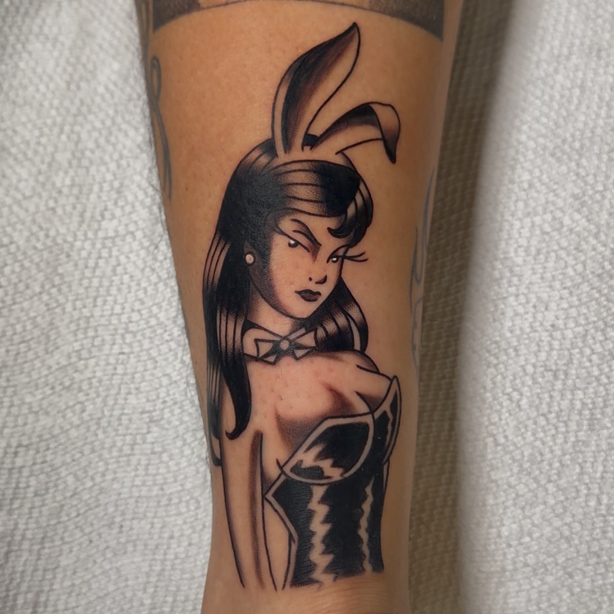 Woman with rabbit ears American traditional tattoo on the forearm by Brian Diaz