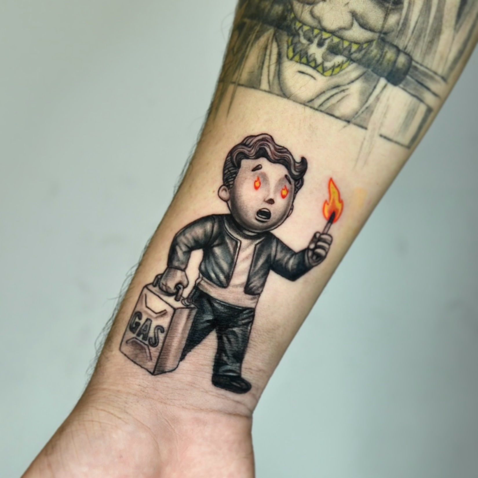 Boy with gas can and match black and grey tattoo on the forearm by Milk Tattoos 🇸🇻🇪🇸
