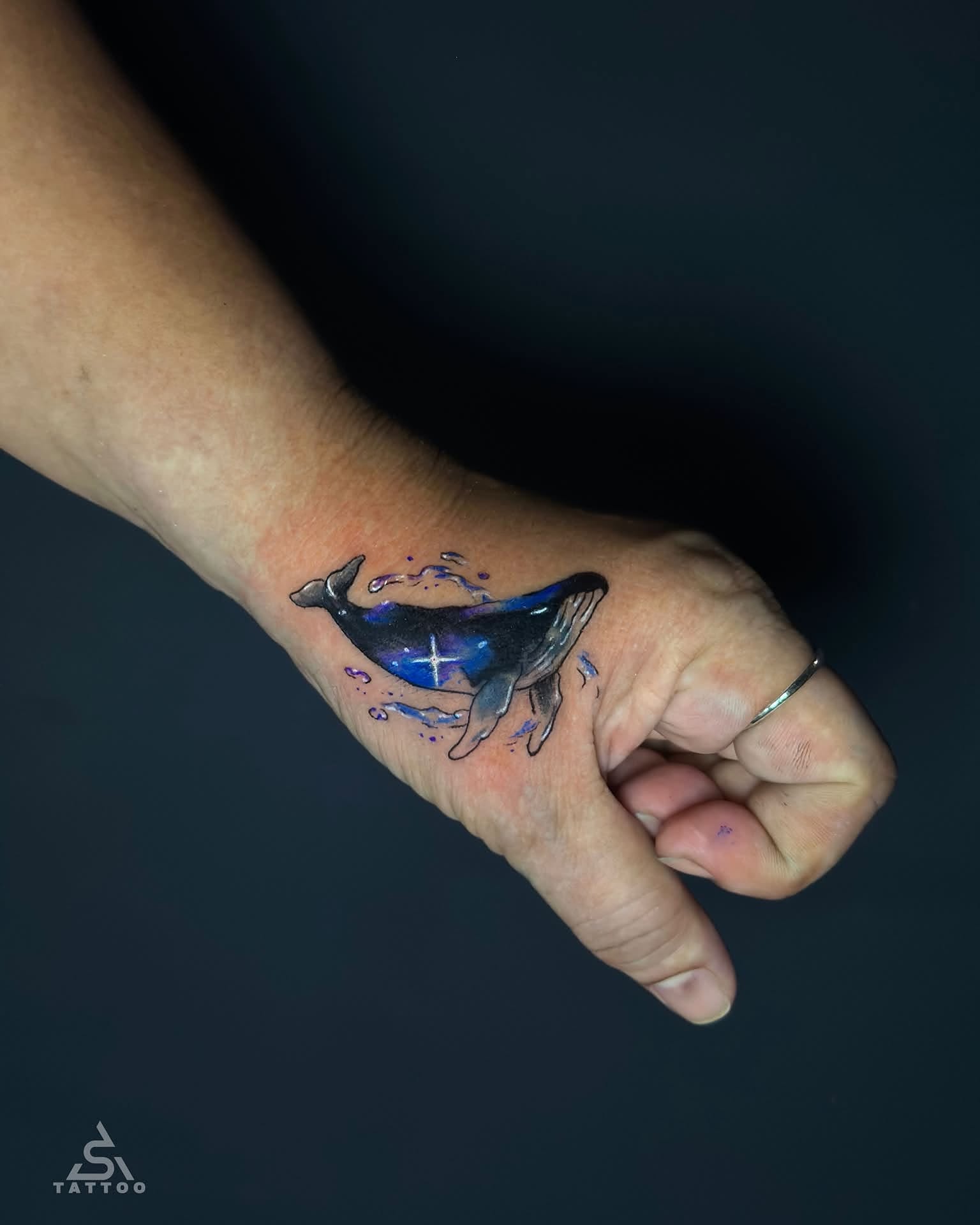 Whale watercolor tattoo on the hand by Stephen Degracia