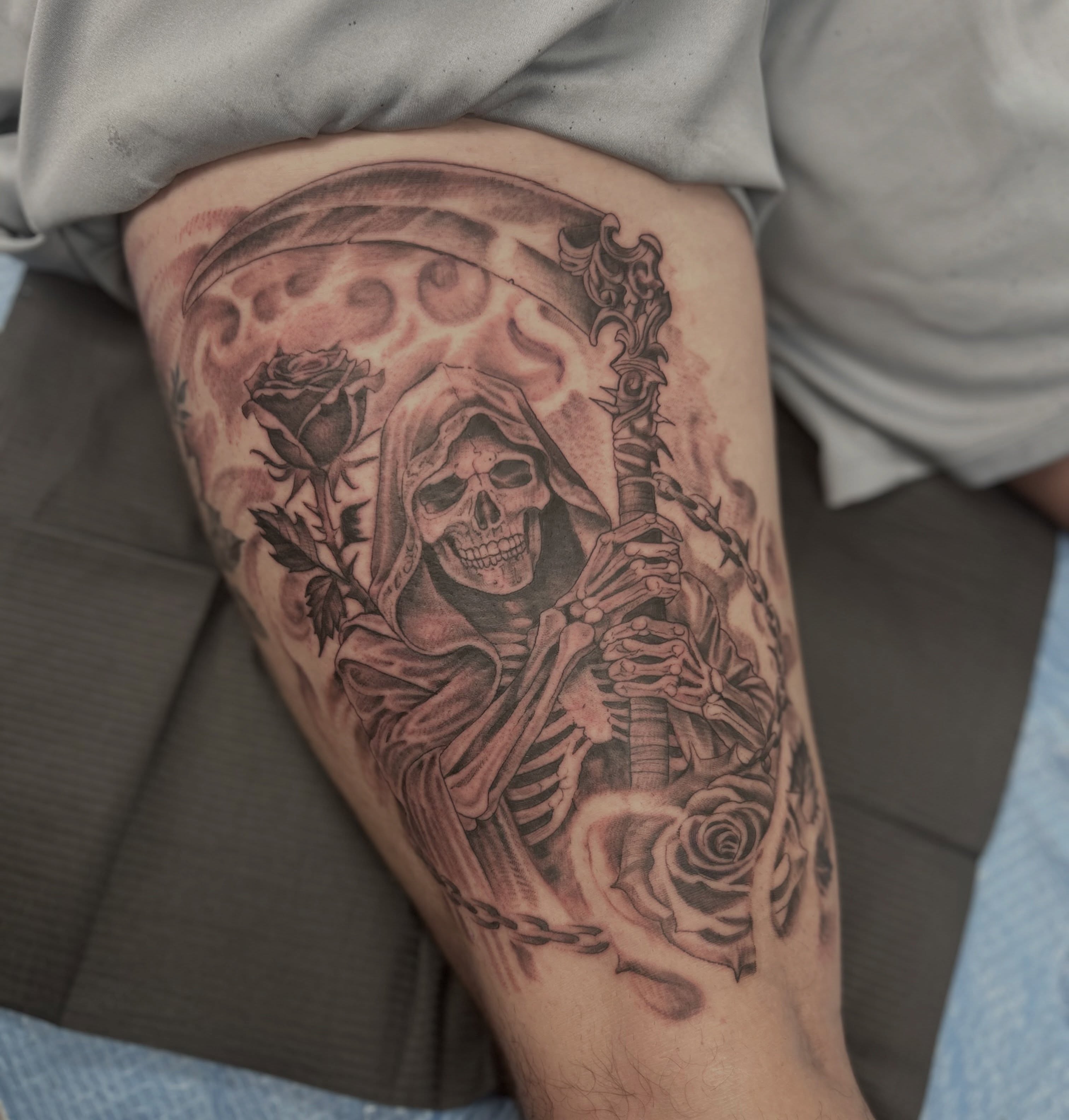 Grim reaper with roses black and grey tattoo on the thigh by Patricia Cunningham