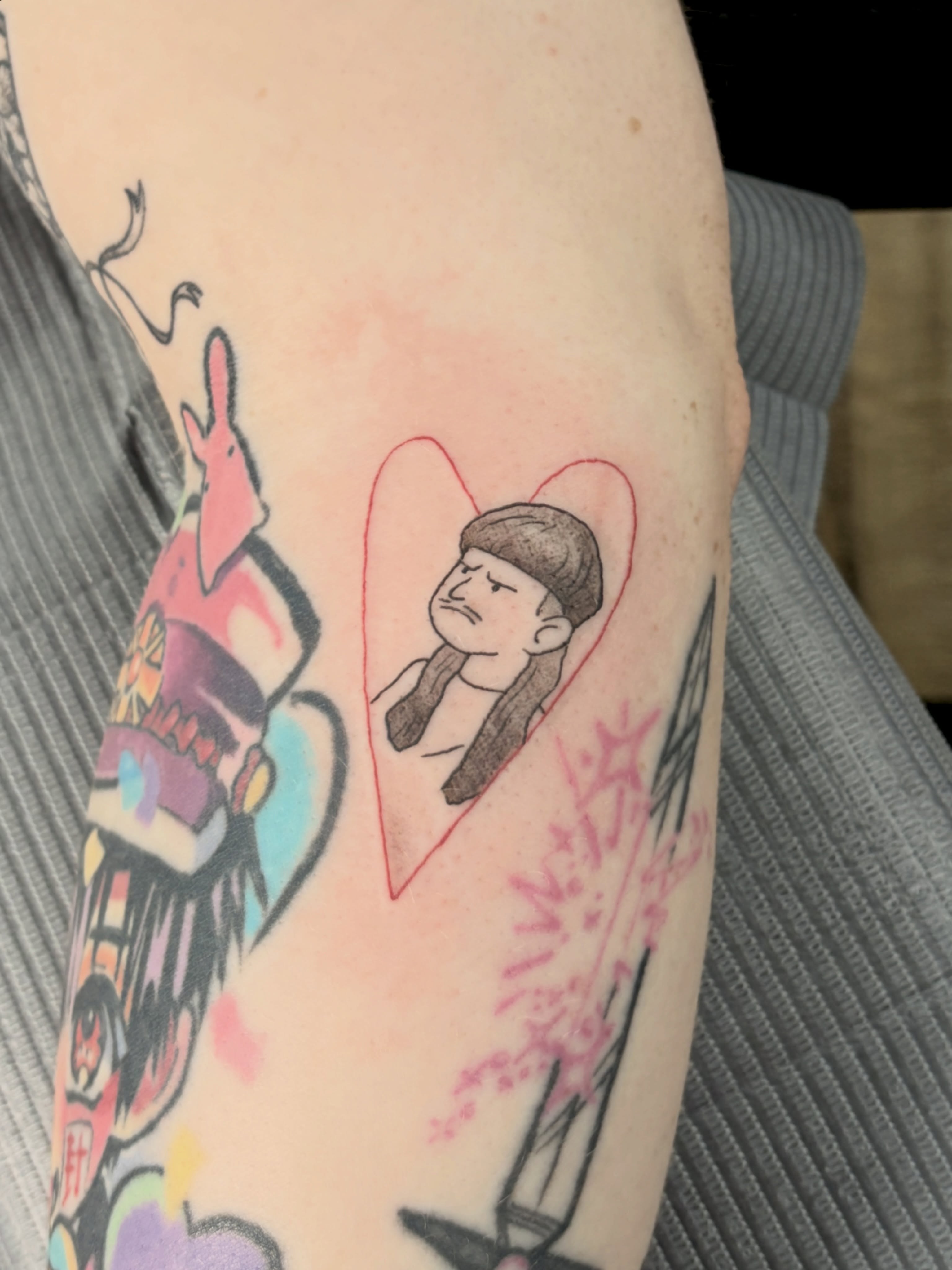Portrait within heart realism tattoo on the forearm by Chris, Cleveland, Ohio