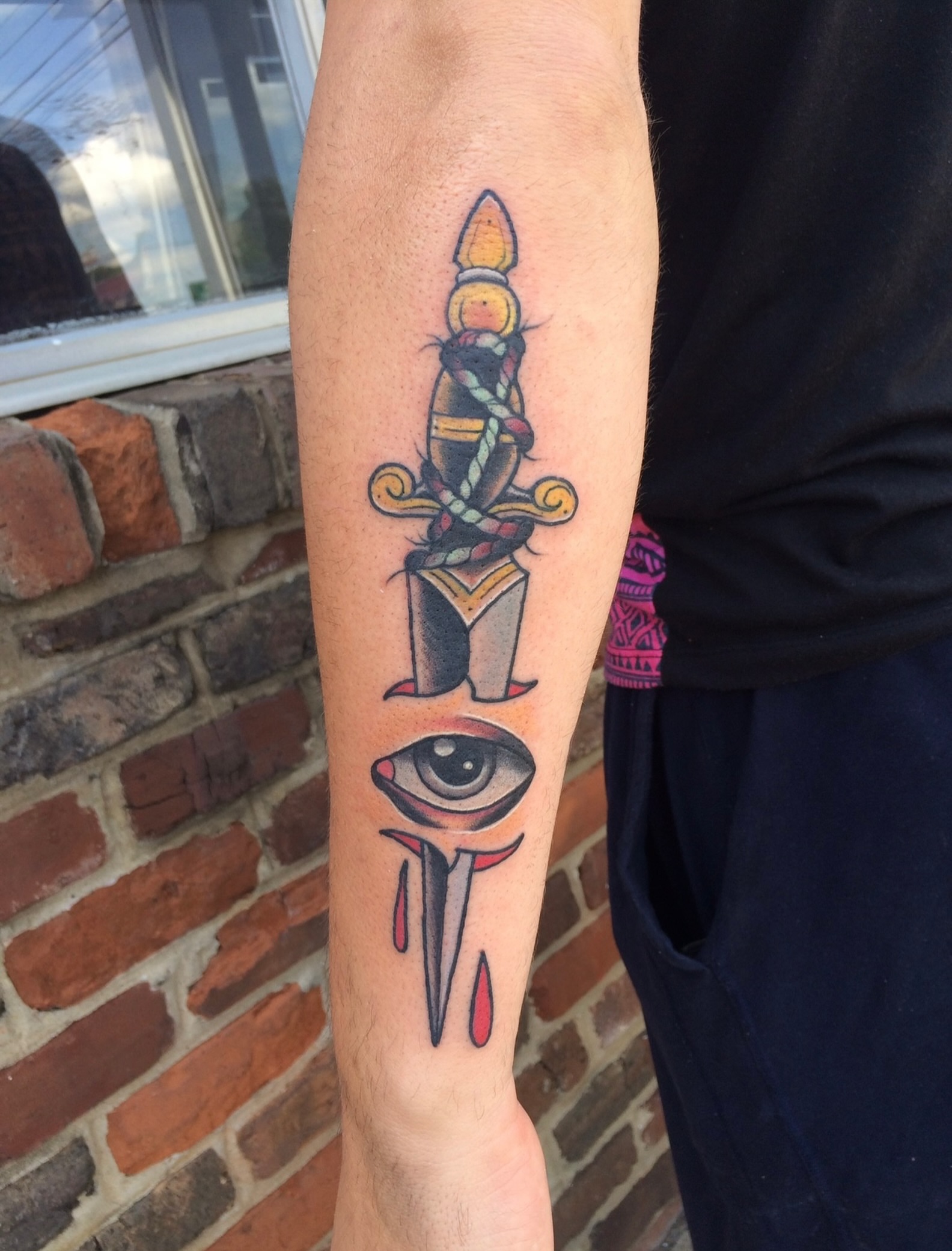 Knife and eye American traditional tattoo on the forearm by Vudu Tattooer