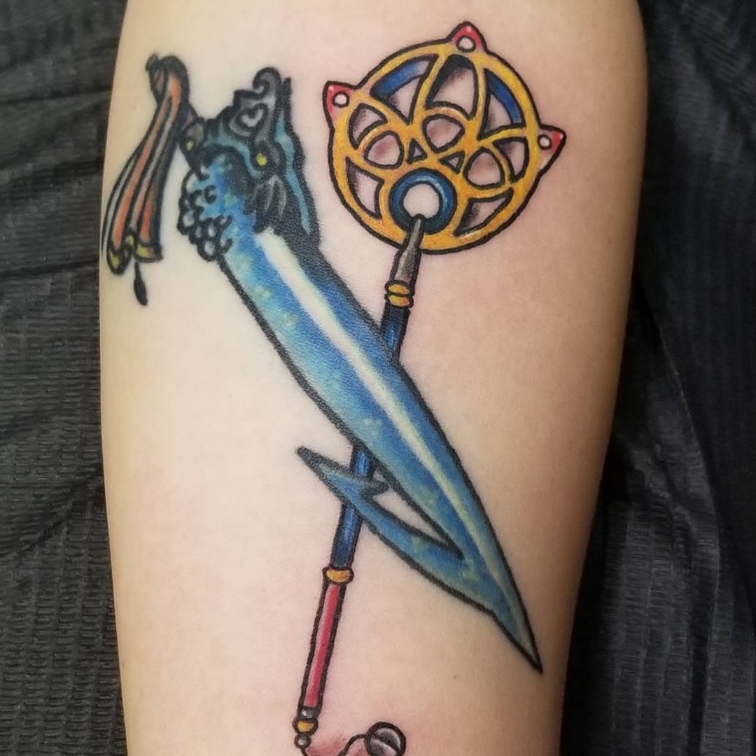 Sword and wheel American traditional tattoo on the forearm by Christopher Anderson-arnesen