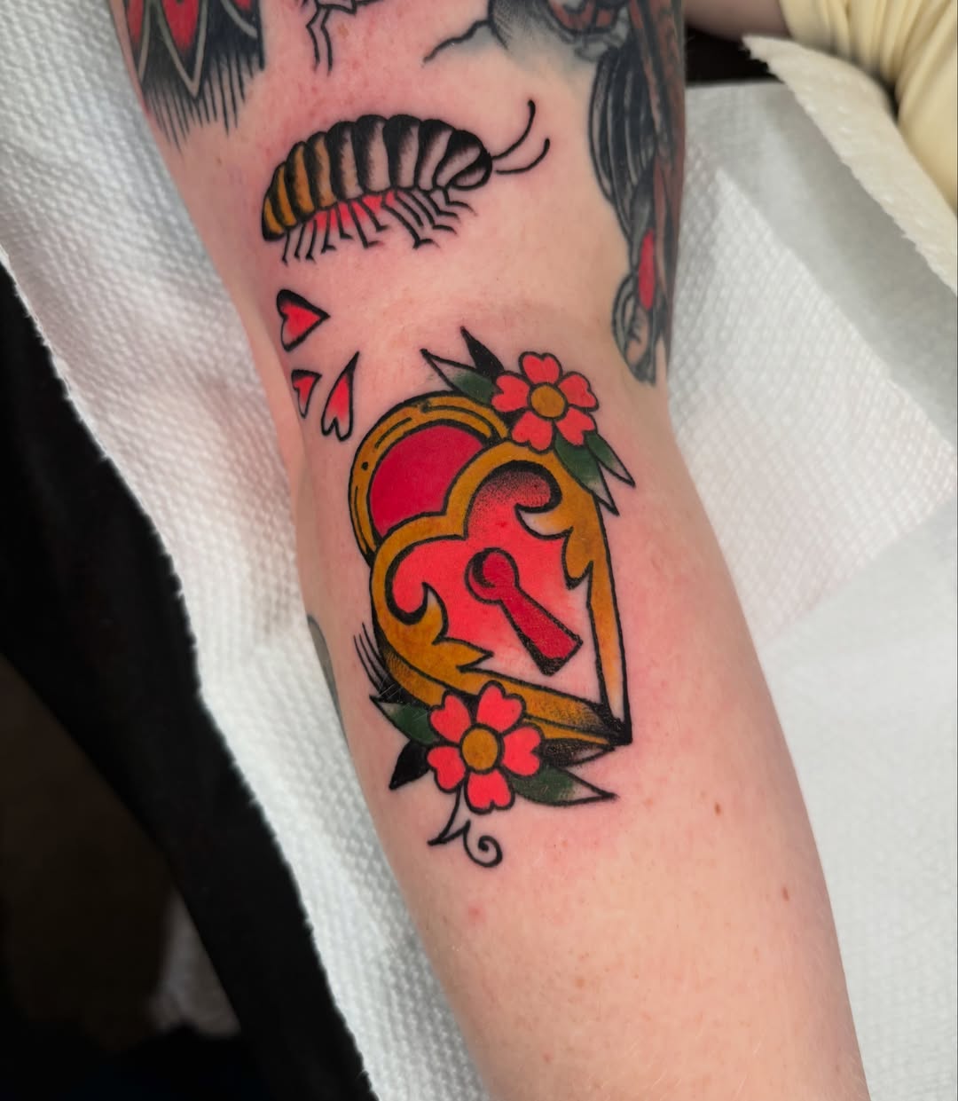 Heart with keyhole American traditional tattoo on the forearm by ericka bates