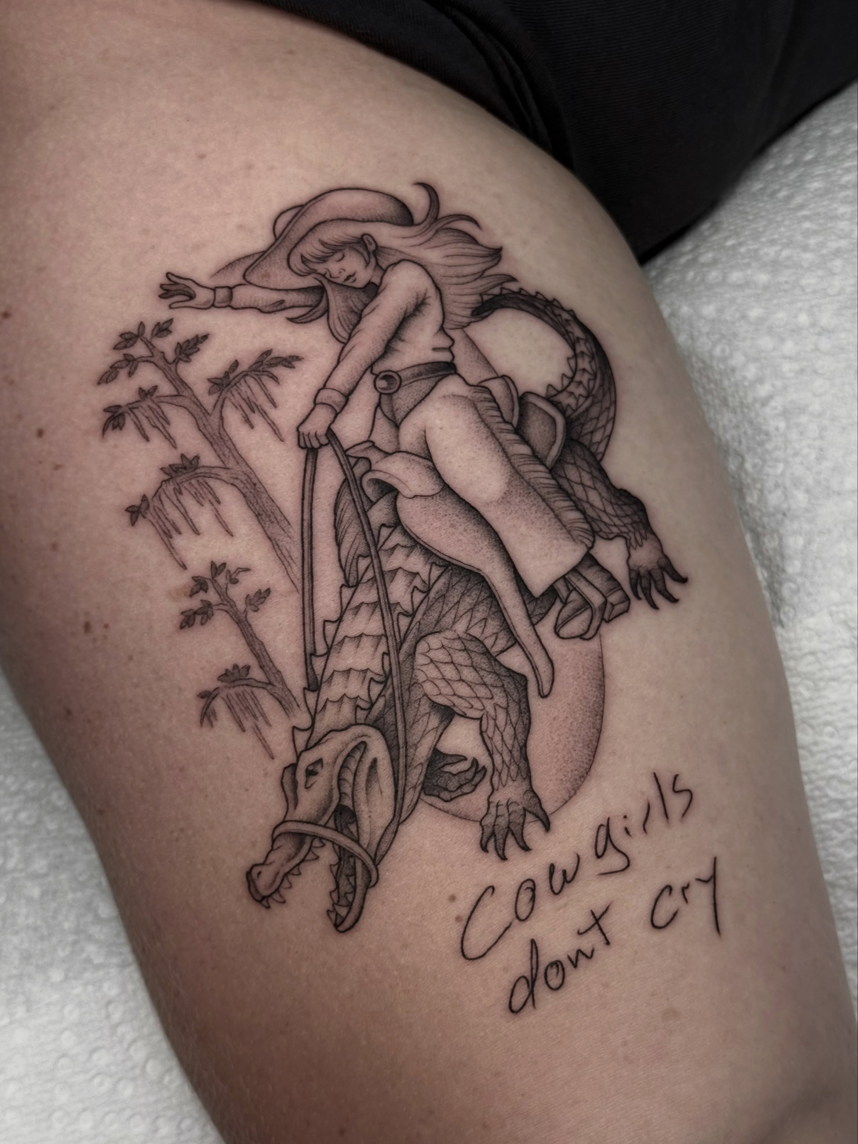 Cowgirl riding dragon realism tattoo on the thigh by Carlos Abad